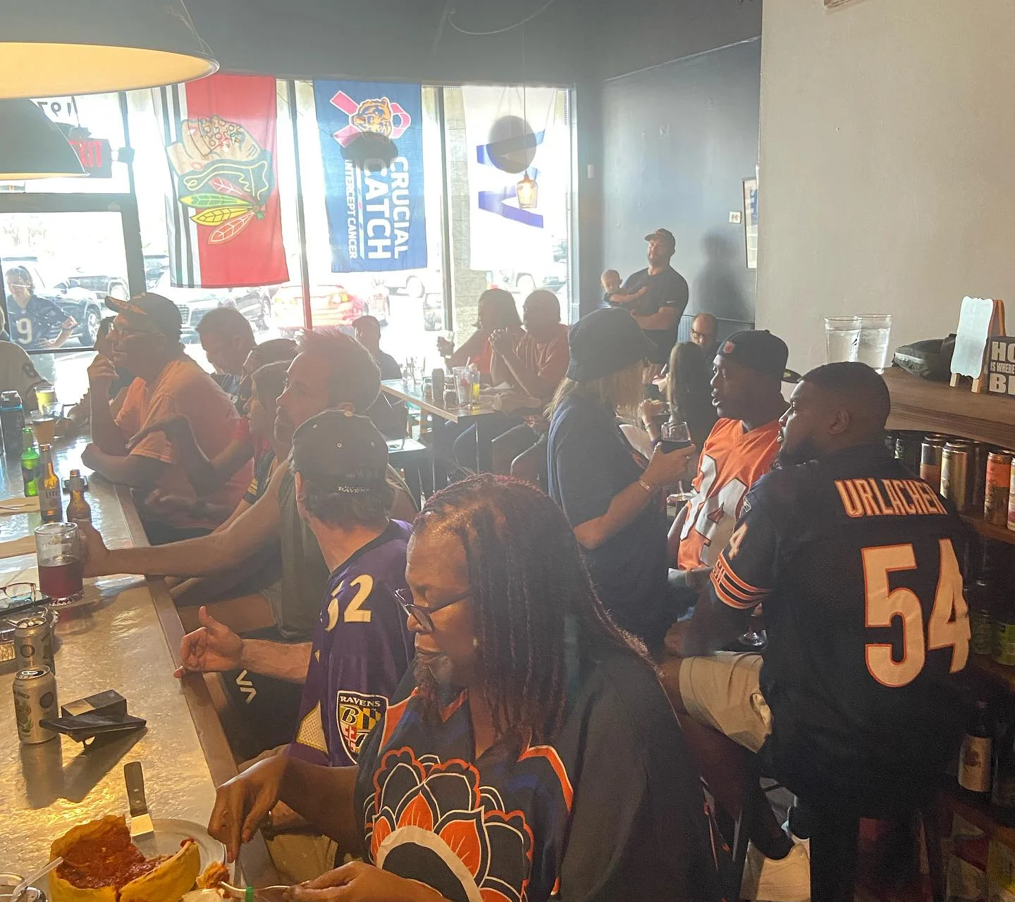 Diners enjoying Chicago-style deep dish pizza in a lively restaurant