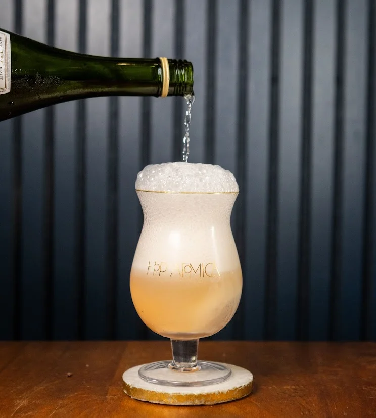 Pouring sparkling wine into a glass with frothy bubbles