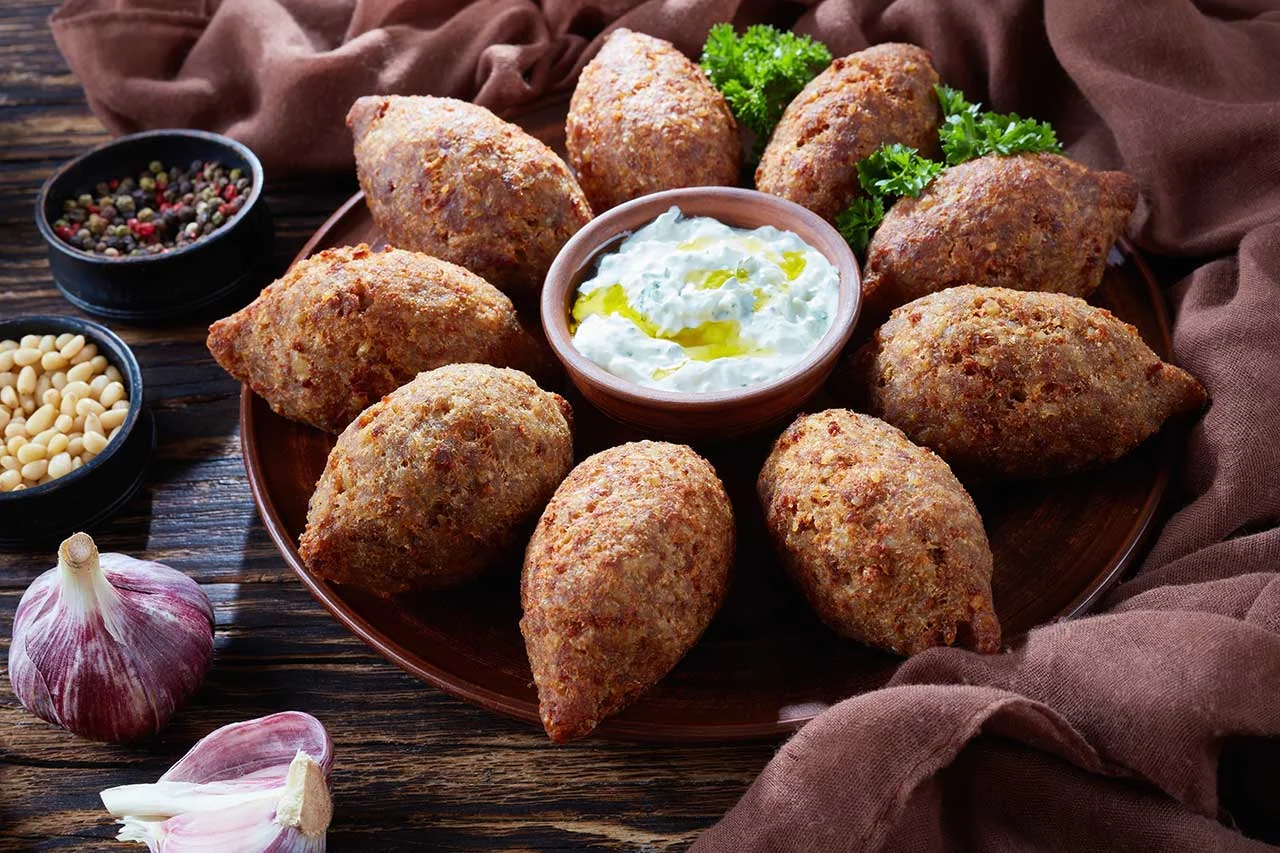 Delicious kibbeh served with yogurt sauce