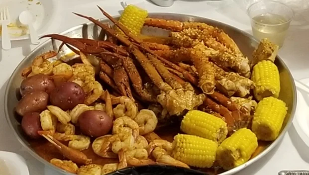 Seafood boil platter with crab, shrimp, and corn