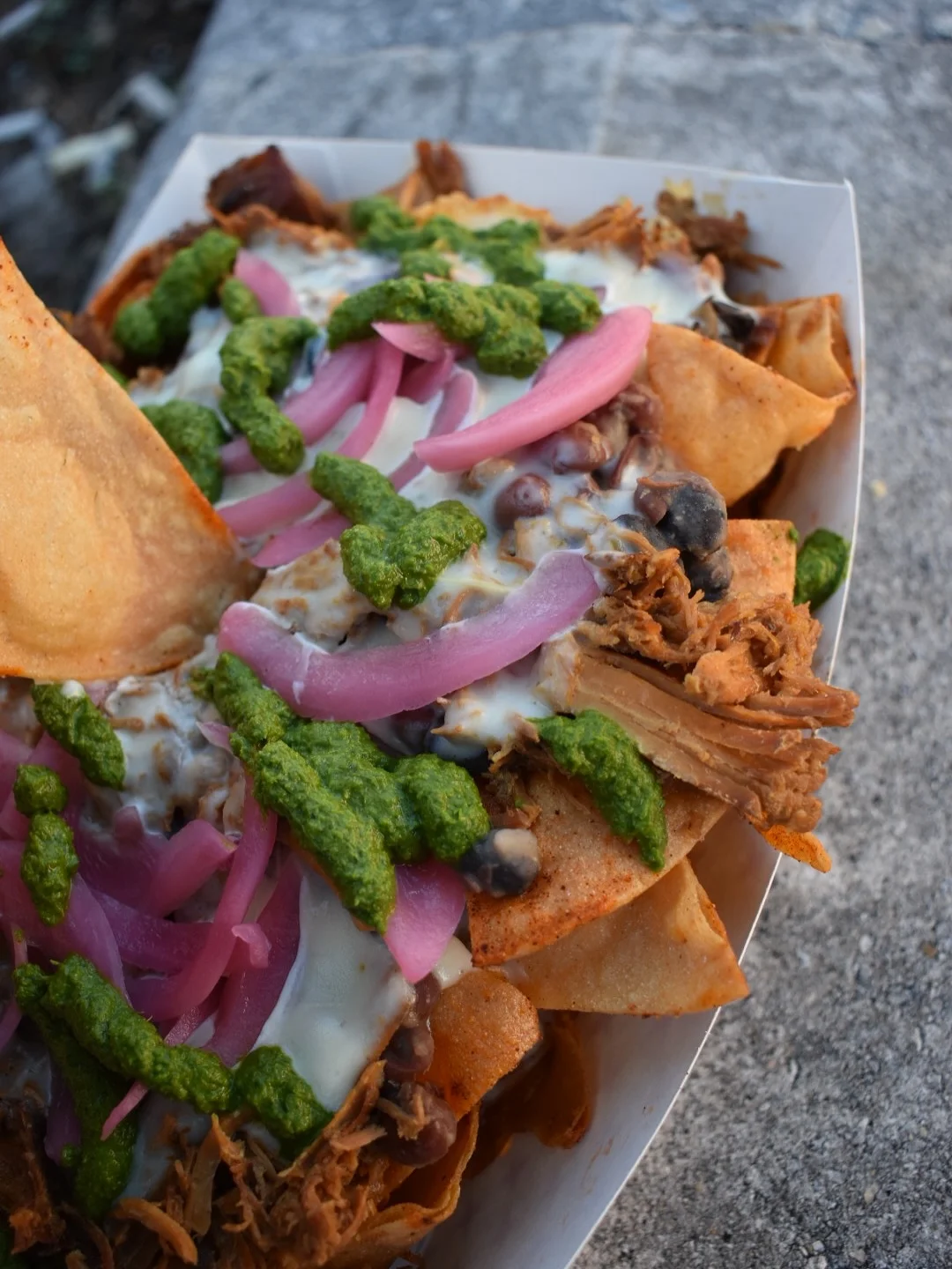 Loaded Mexican nachos with pulled pork and toppings