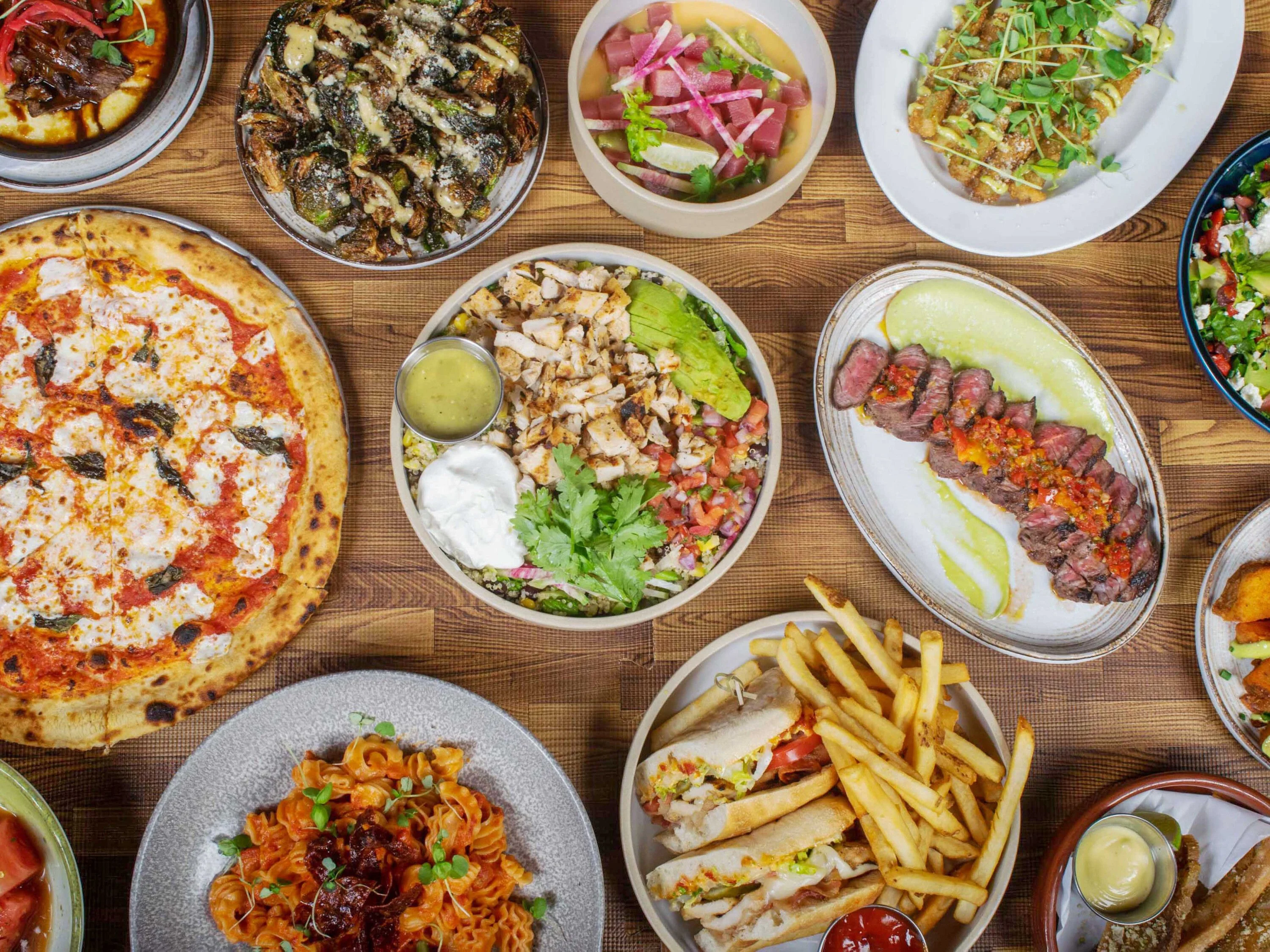 Assorted global dishes including pizza, pasta, and grilled steak
