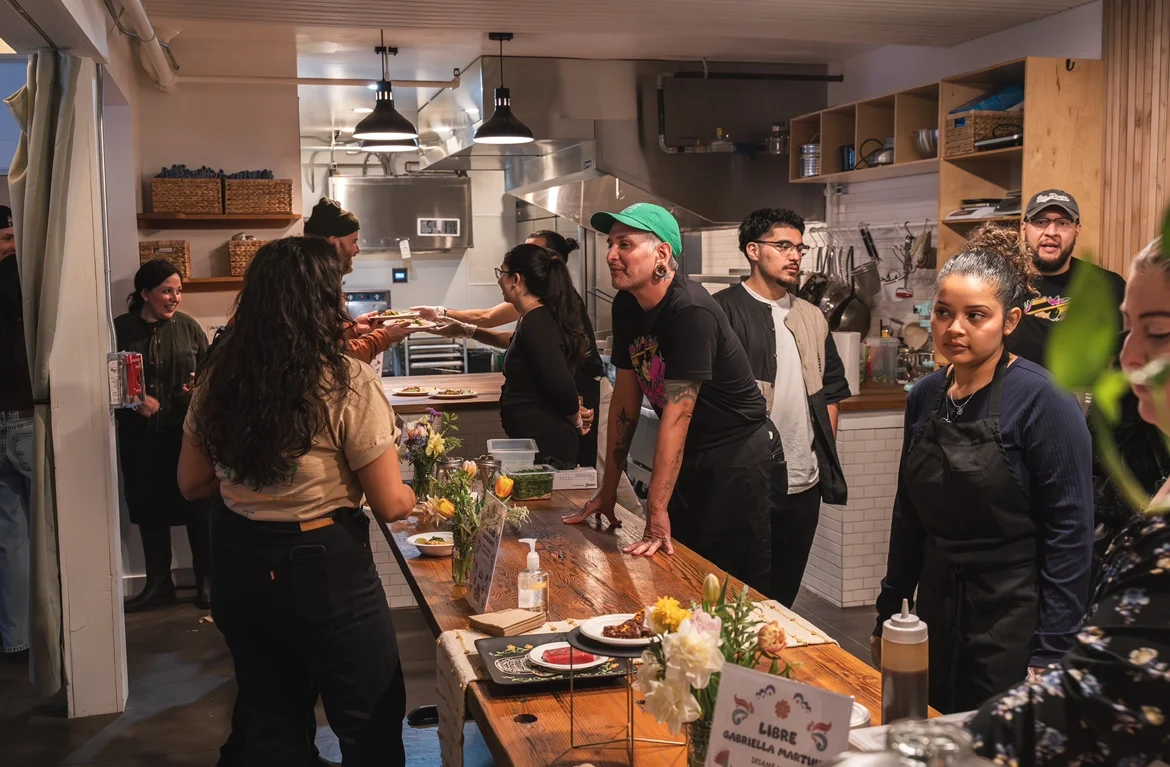 Vibrant restaurant interior with staff serving dishes