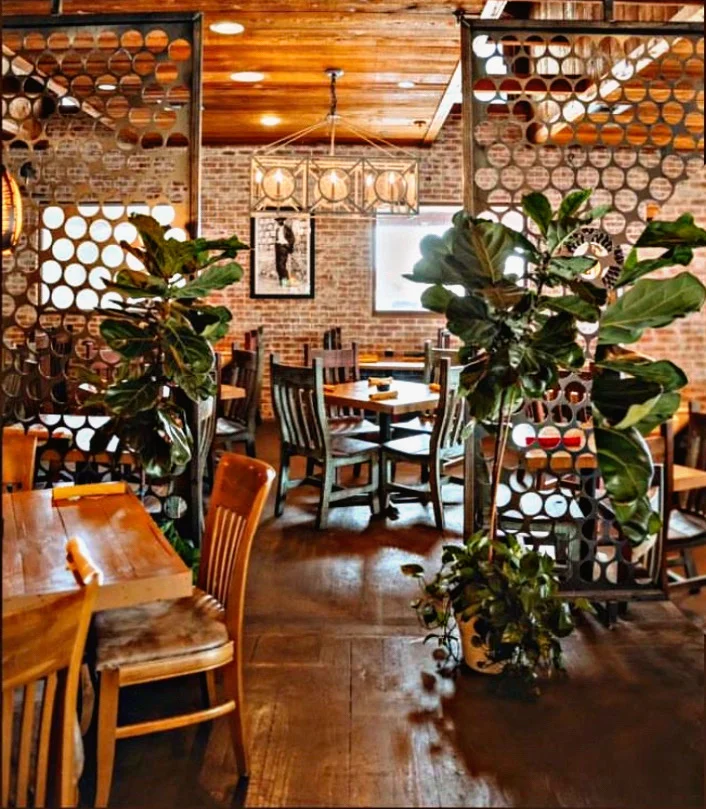 Cozy restaurant interior with rustic decor and greenery