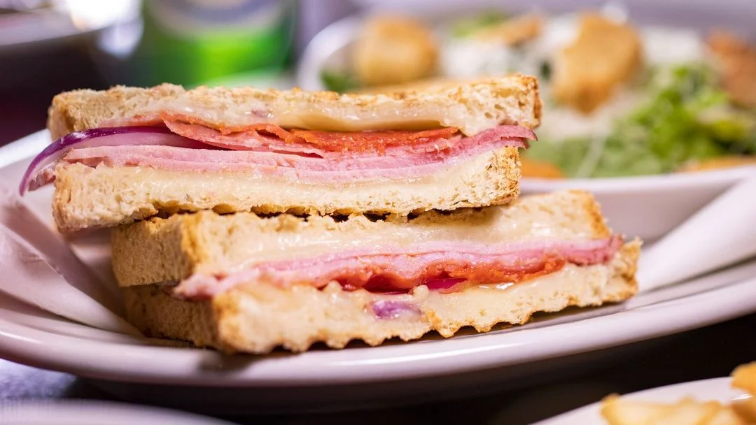 Cuban sandwich with layers of ham and cheese