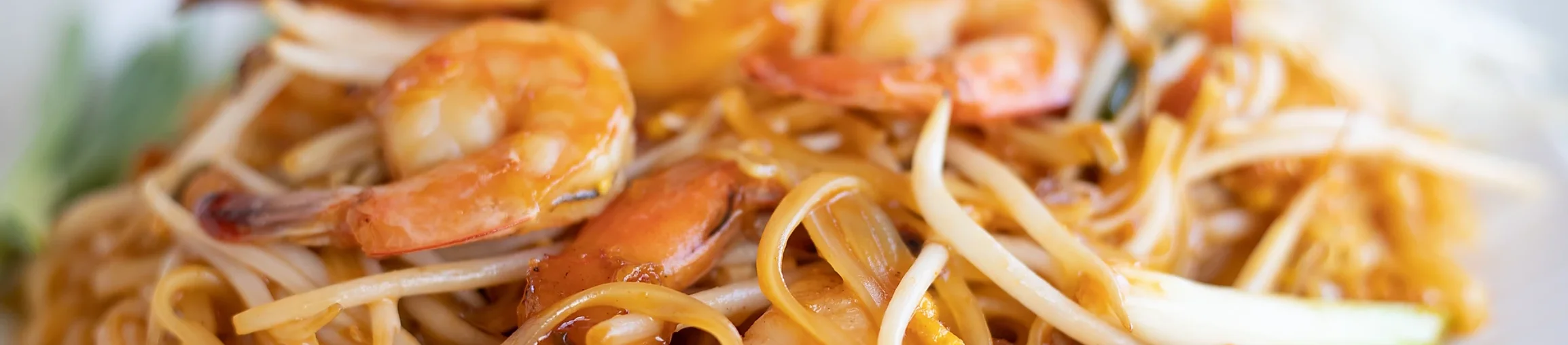 Shrimp pad thai with rice noodles and fresh herbs