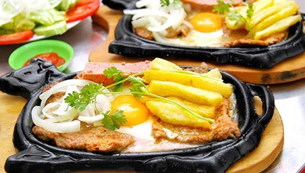 Sizzling Mexican fajitas served on a hot plate