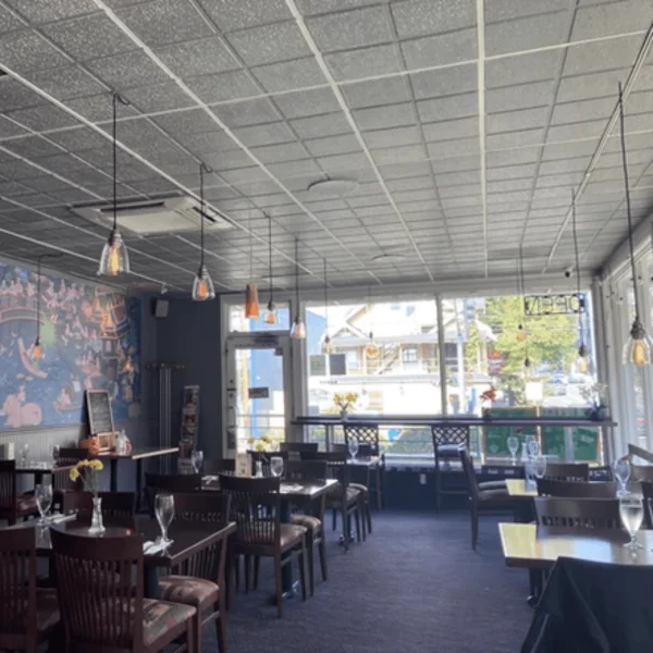 Cozy restaurant interior with modern lighting and large windows