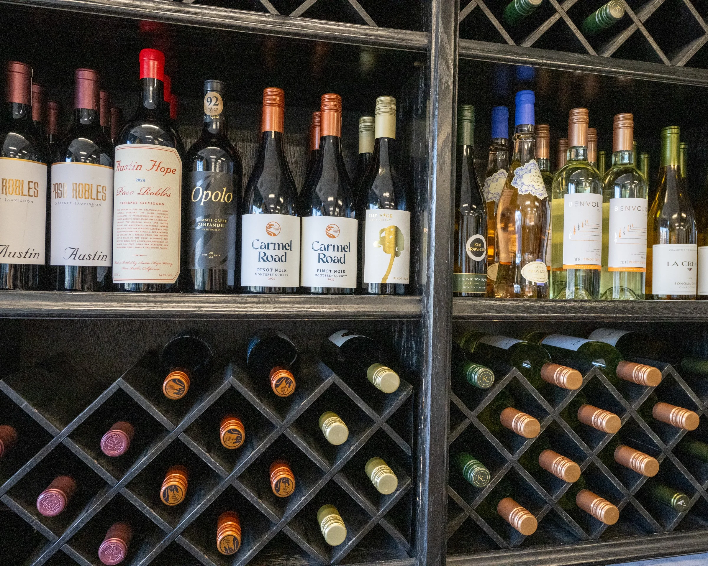 Restaurant wine rack displaying an assortment of red, white, and rosé wines