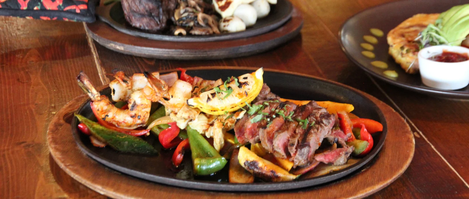 Delicious fajitas served with colorful vegetables and garnishes.
