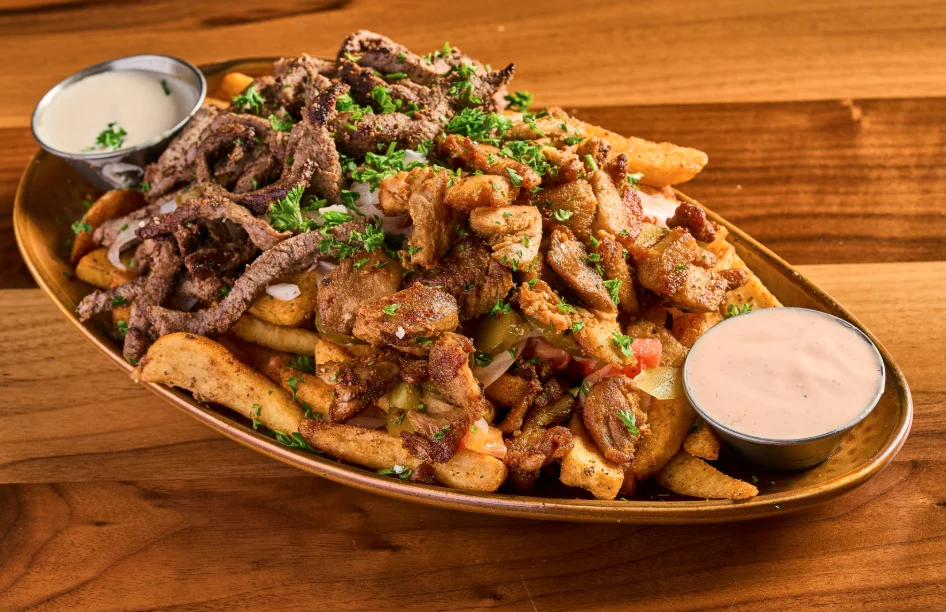 Shawarma fries topped with shawarma meat and sauces.