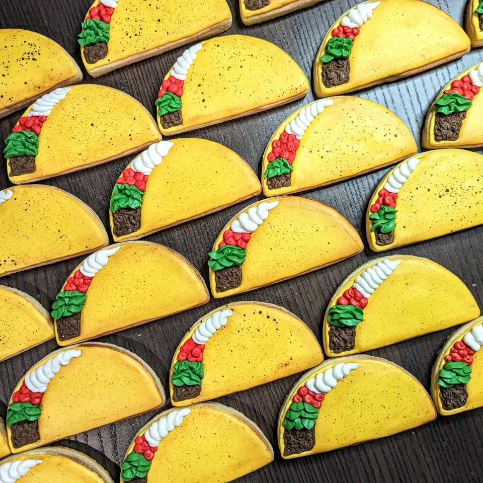 Colorful taco-shaped cookies decorated with icing