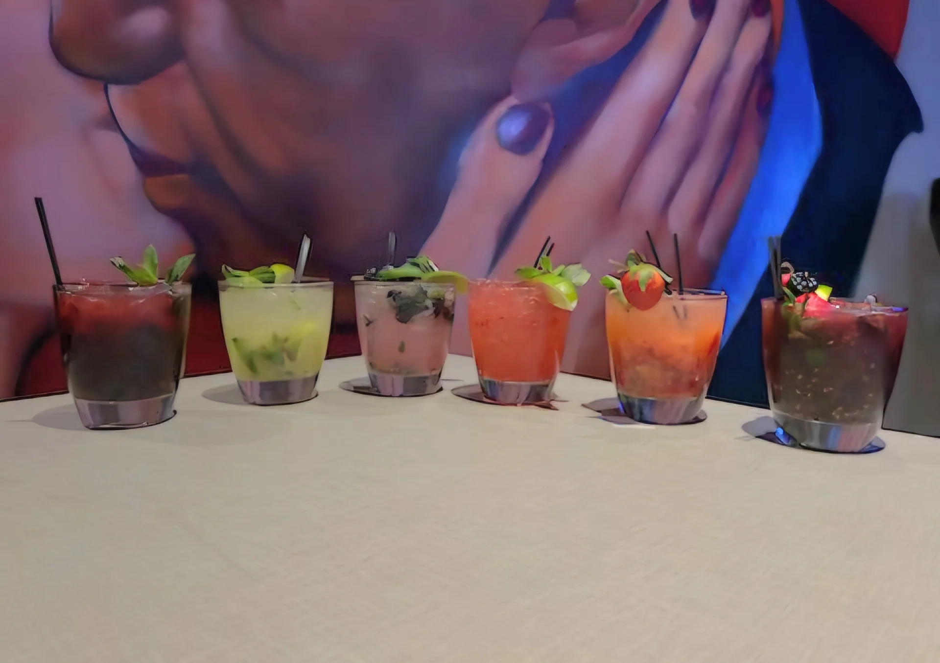 Colorful cocktails arranged on a table in a vibrant bar setting