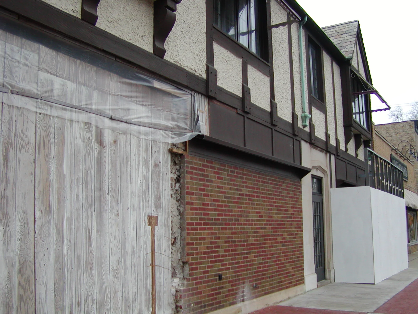 Exterior view of a building under renovation with wooden and brick elements