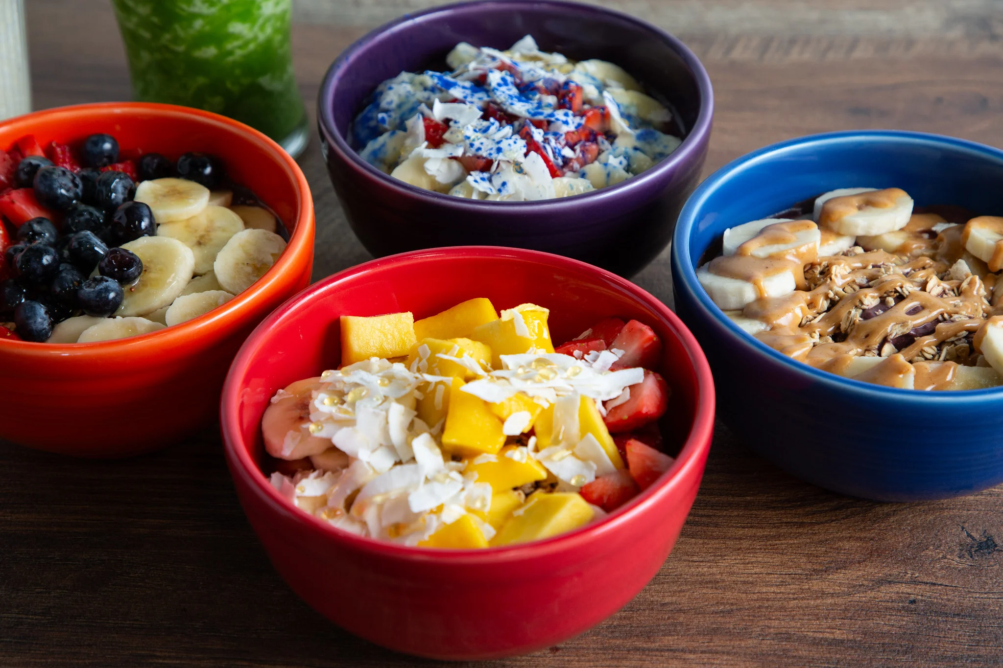 Colorful smoothie bowls with fresh fruits and toppings