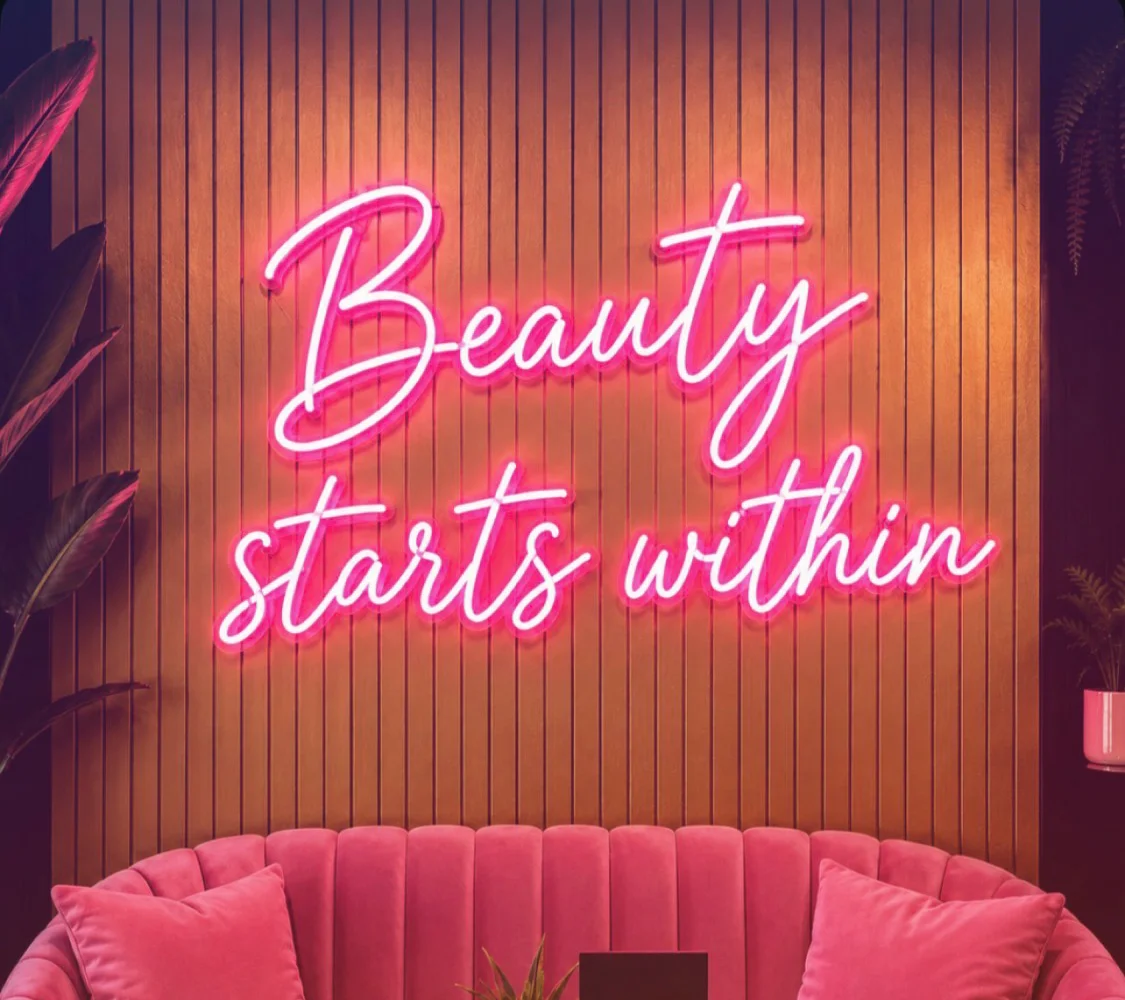 Stylish restaurant interior with neon sign and pink seating