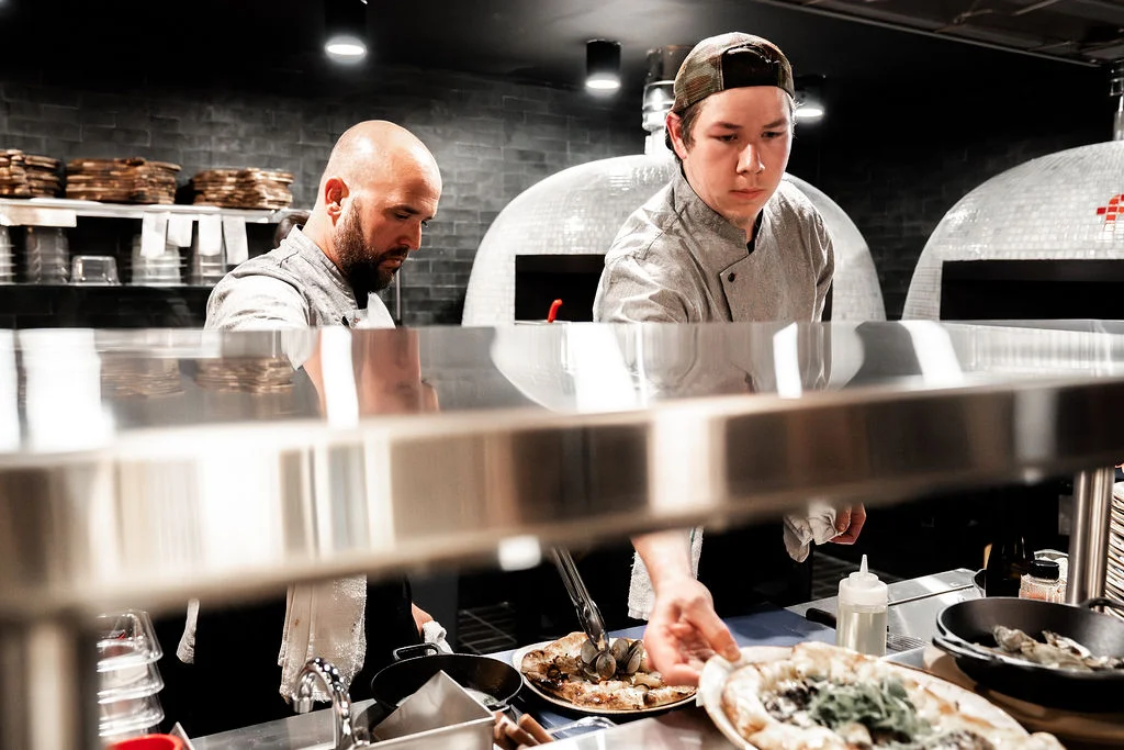 Chefs preparing gourmet dishes in a modern kitchen