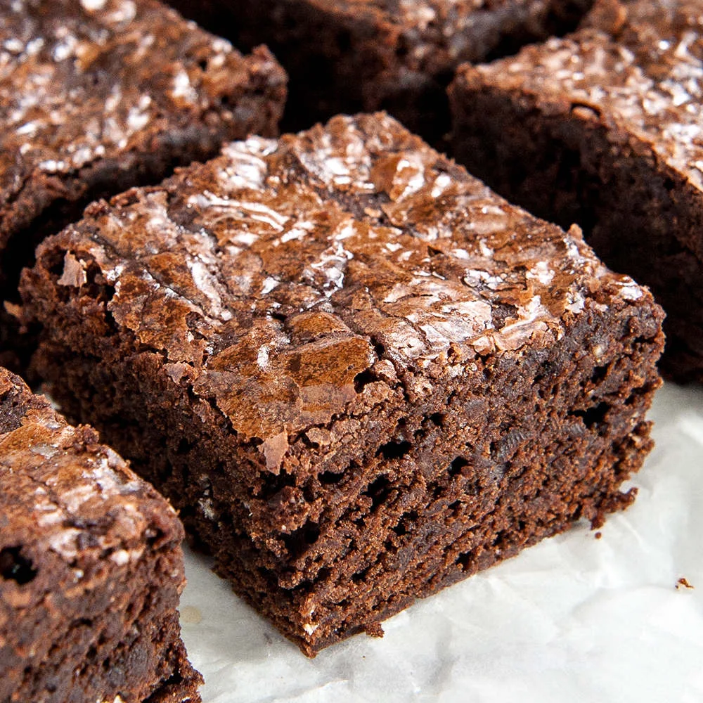 Decadent chocolate brownies on parchment paper
