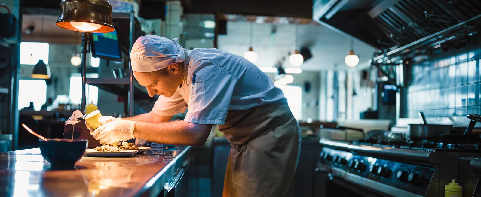 A restaurant chef preparing a dish