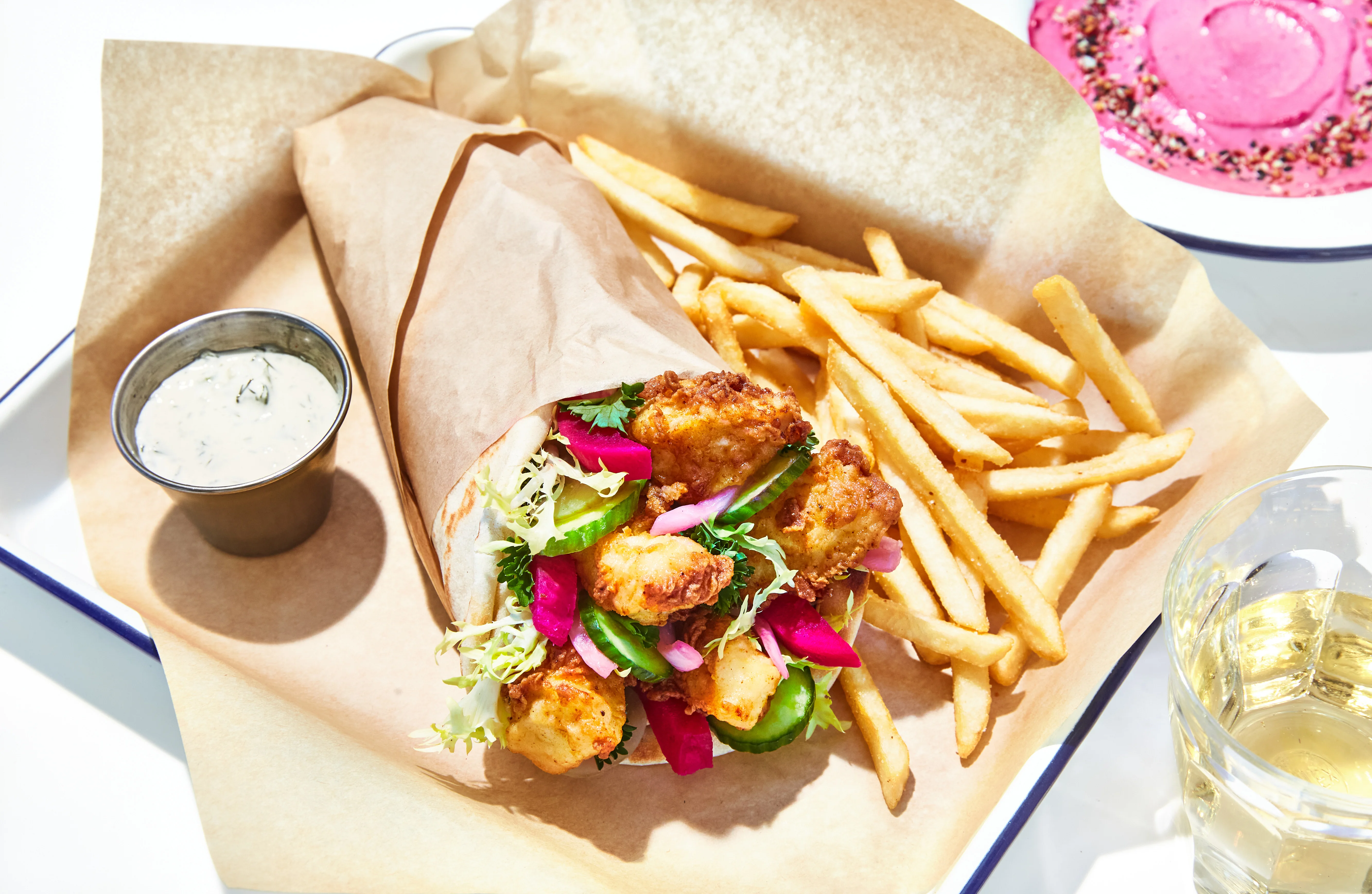 Crispy fish wrap with fries and dipping sauce