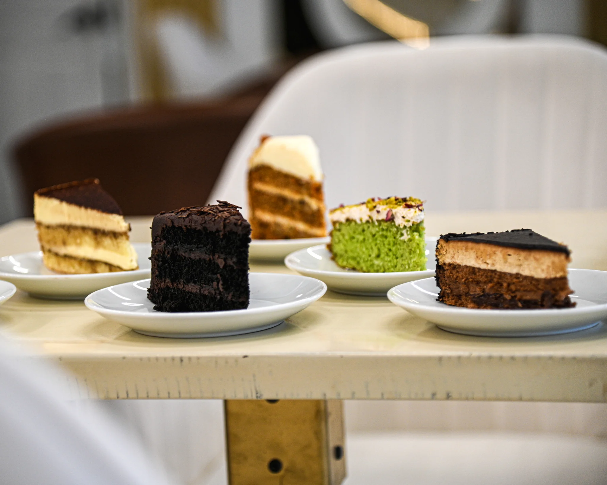 Assorted cake slices including chocolate and green tea desserts