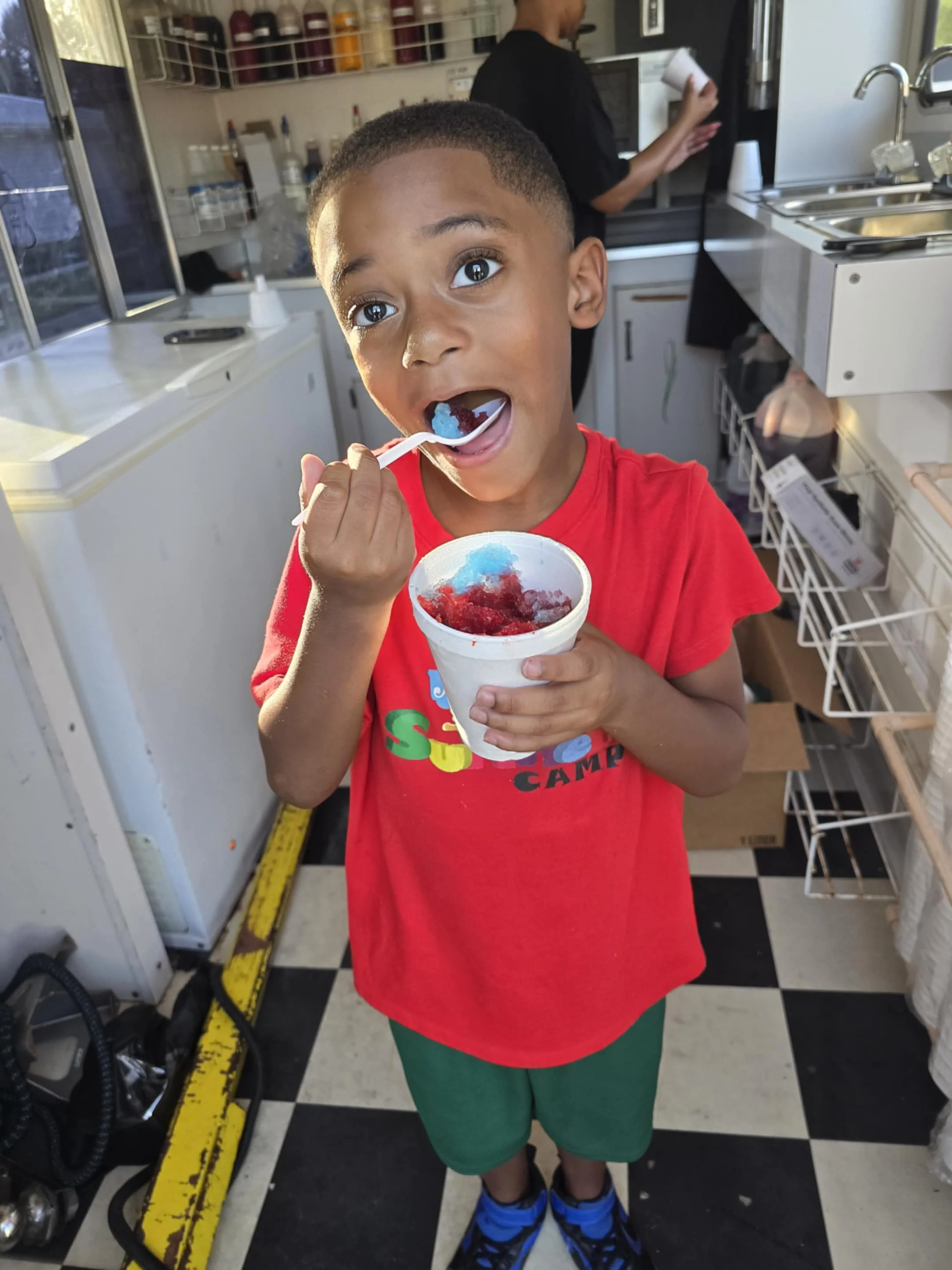 Child enjoying colorful snow cone treat