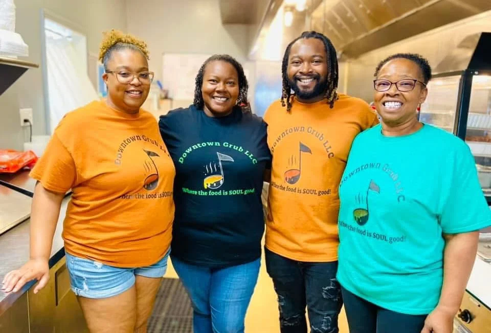 Team members of Downtown Grub LLC in colorful shirts