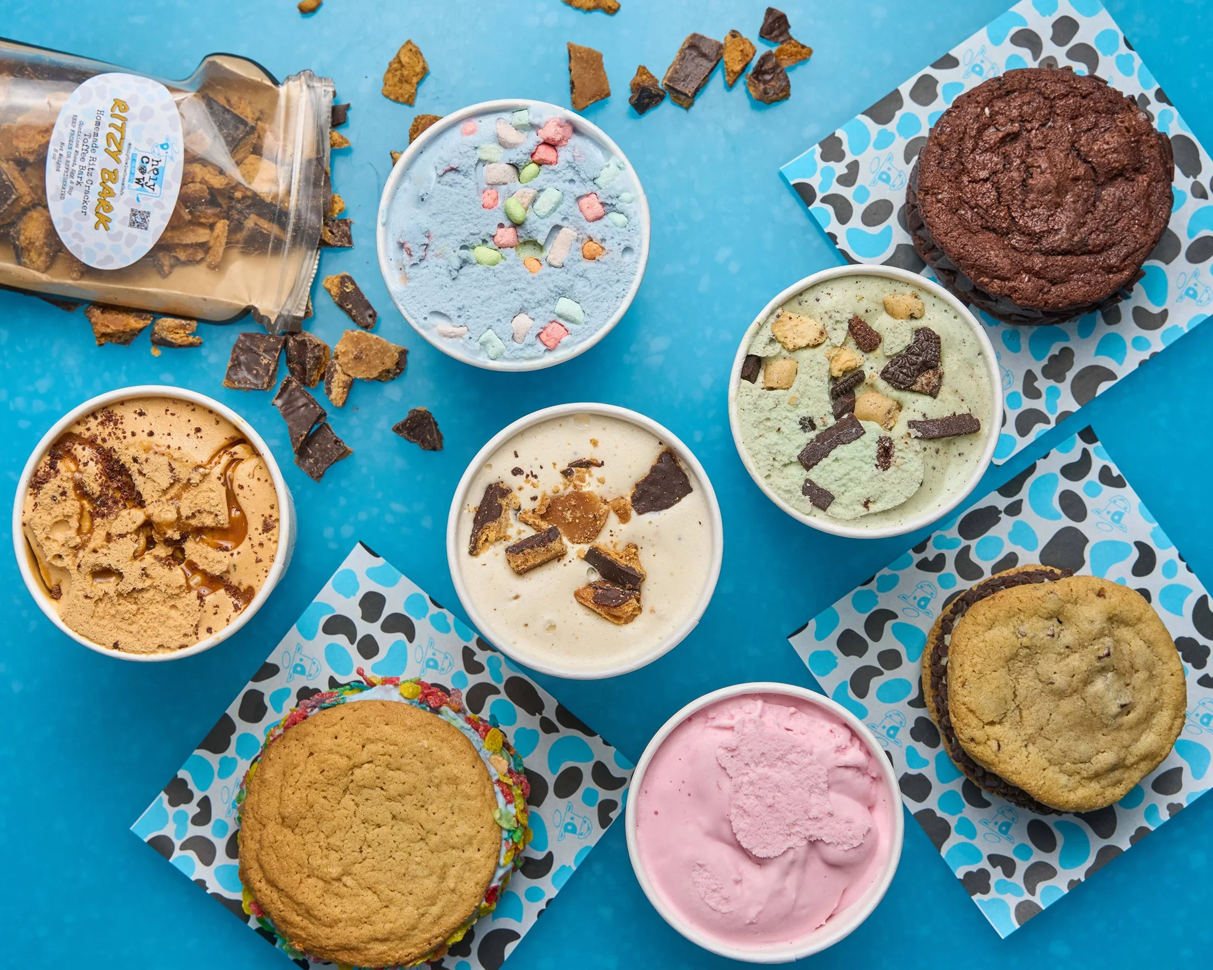 Assorted ice cream flavors with cookies on a blue background
