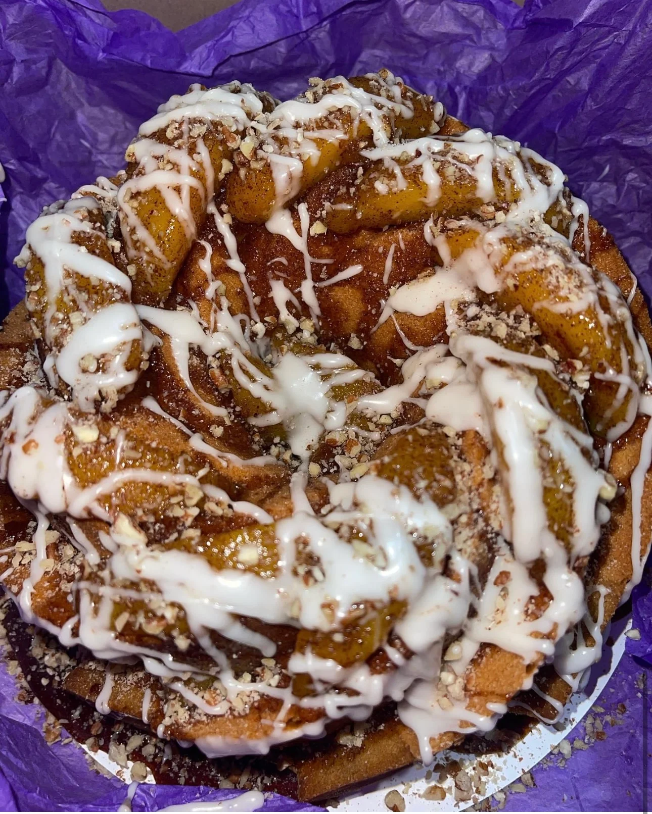 Cinnamon roll cake with icing and nuts