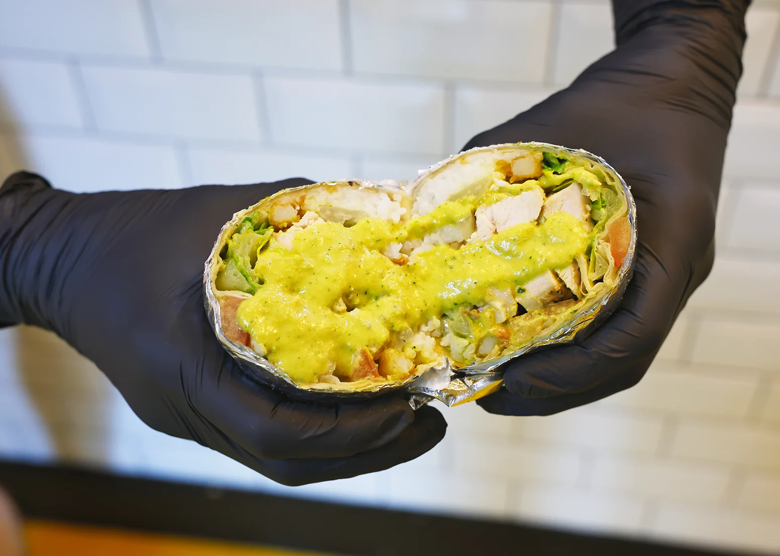 Delicious burrito with chicken and green sauce