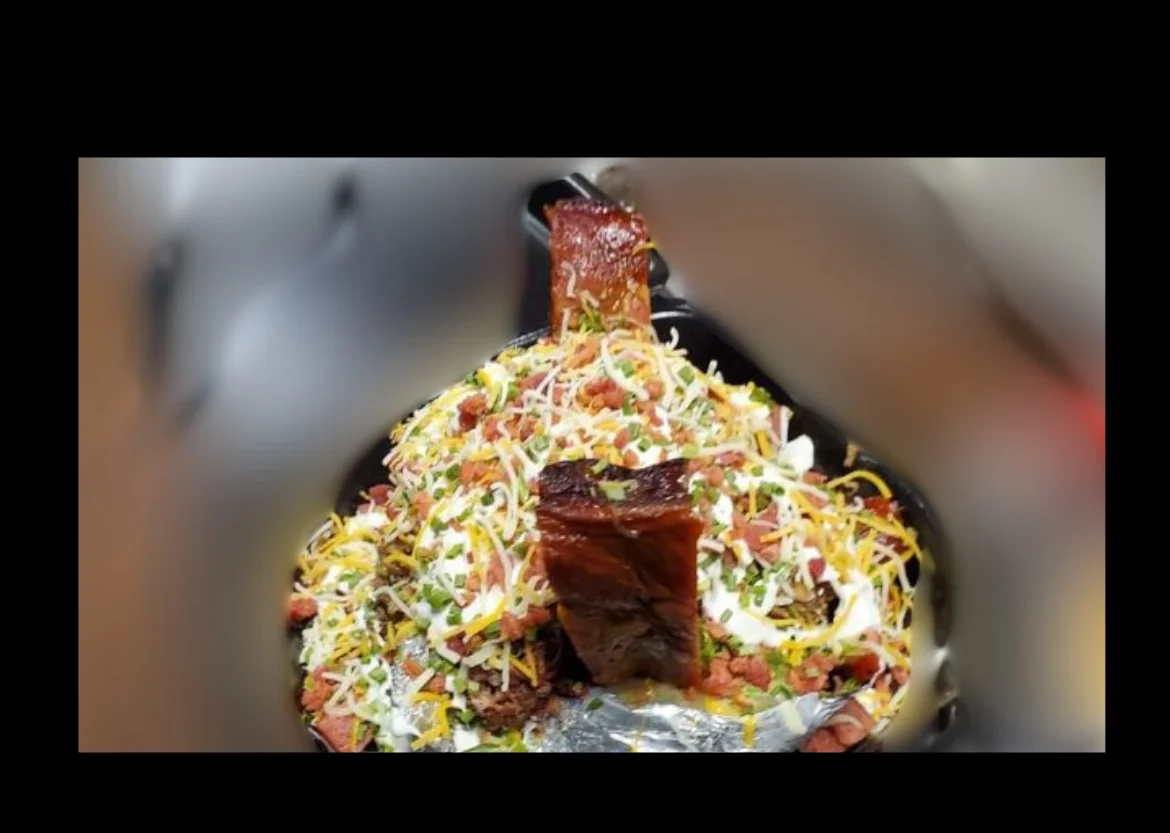 Savory Indian biryani topped with grilled meat and fresh herbs