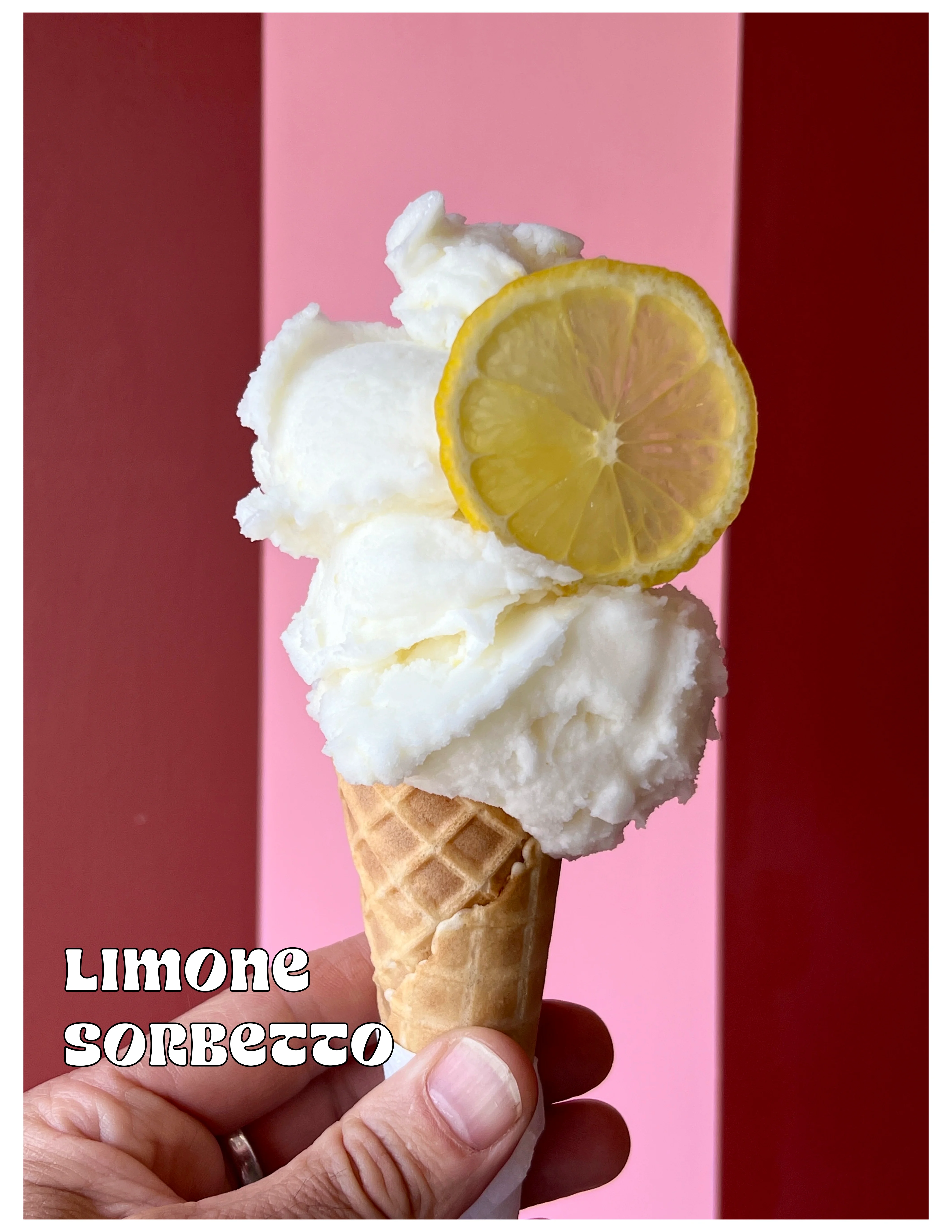 Refreshing limone sorbetto served in a waffle cone with a lemon slice