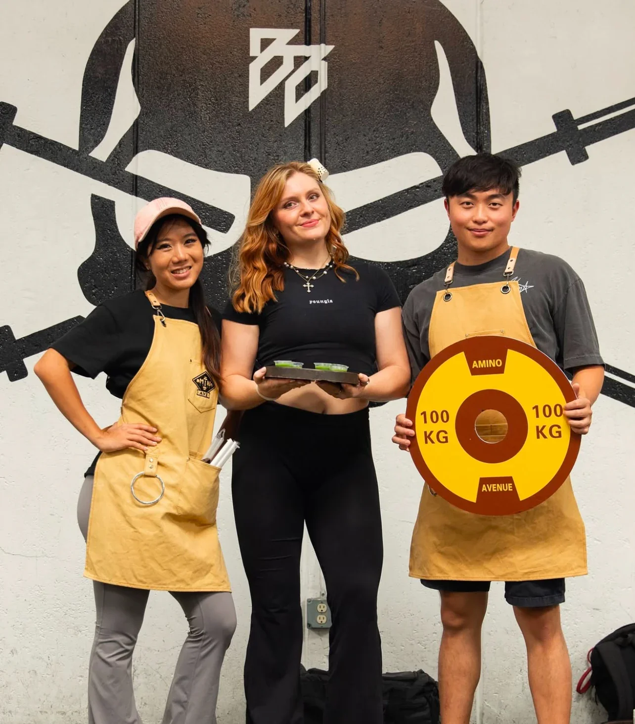 Team members posing with fitness equipment and healthy snacks