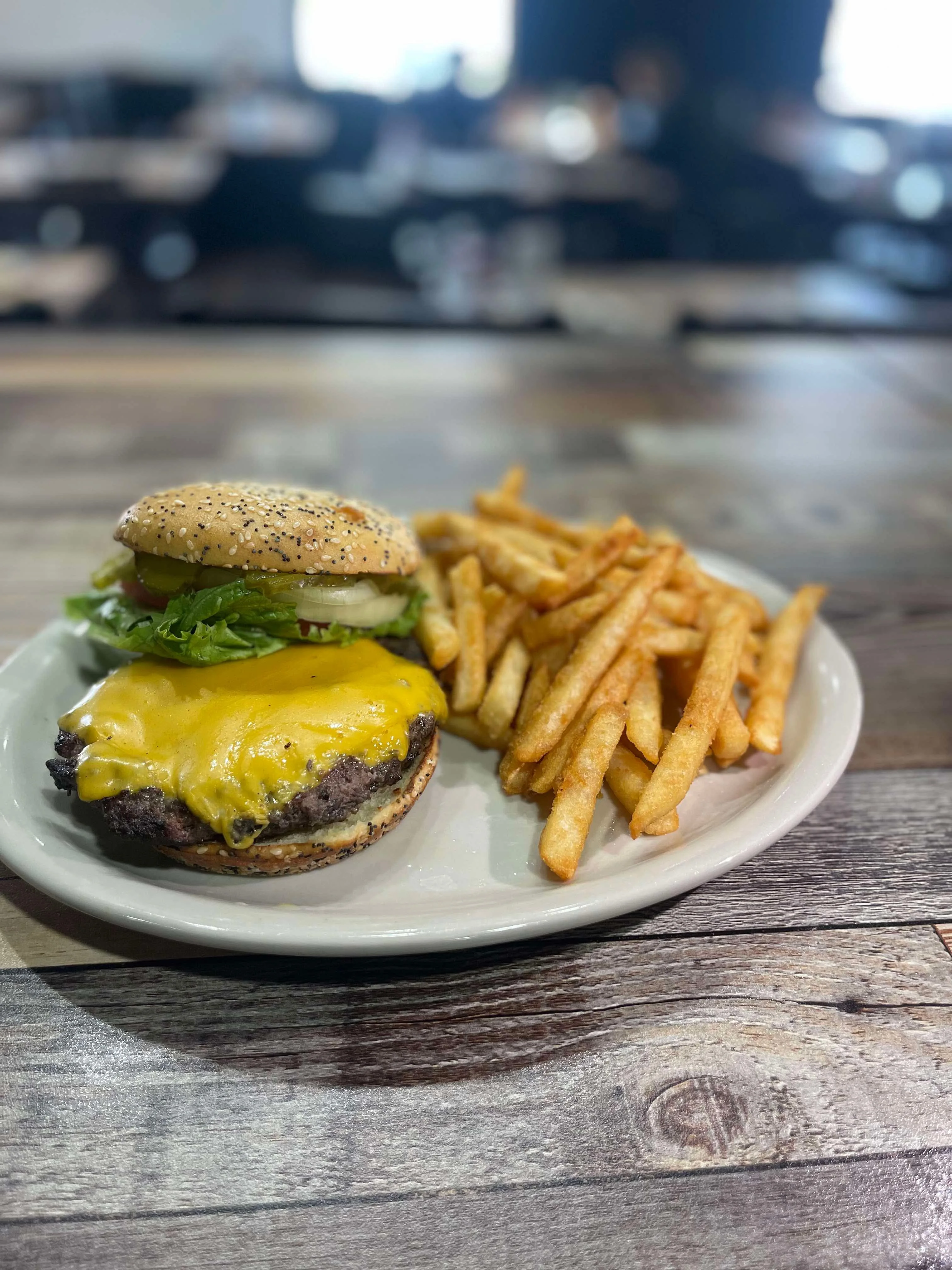 Classic cheeseburger with fries served in a casual dining setting