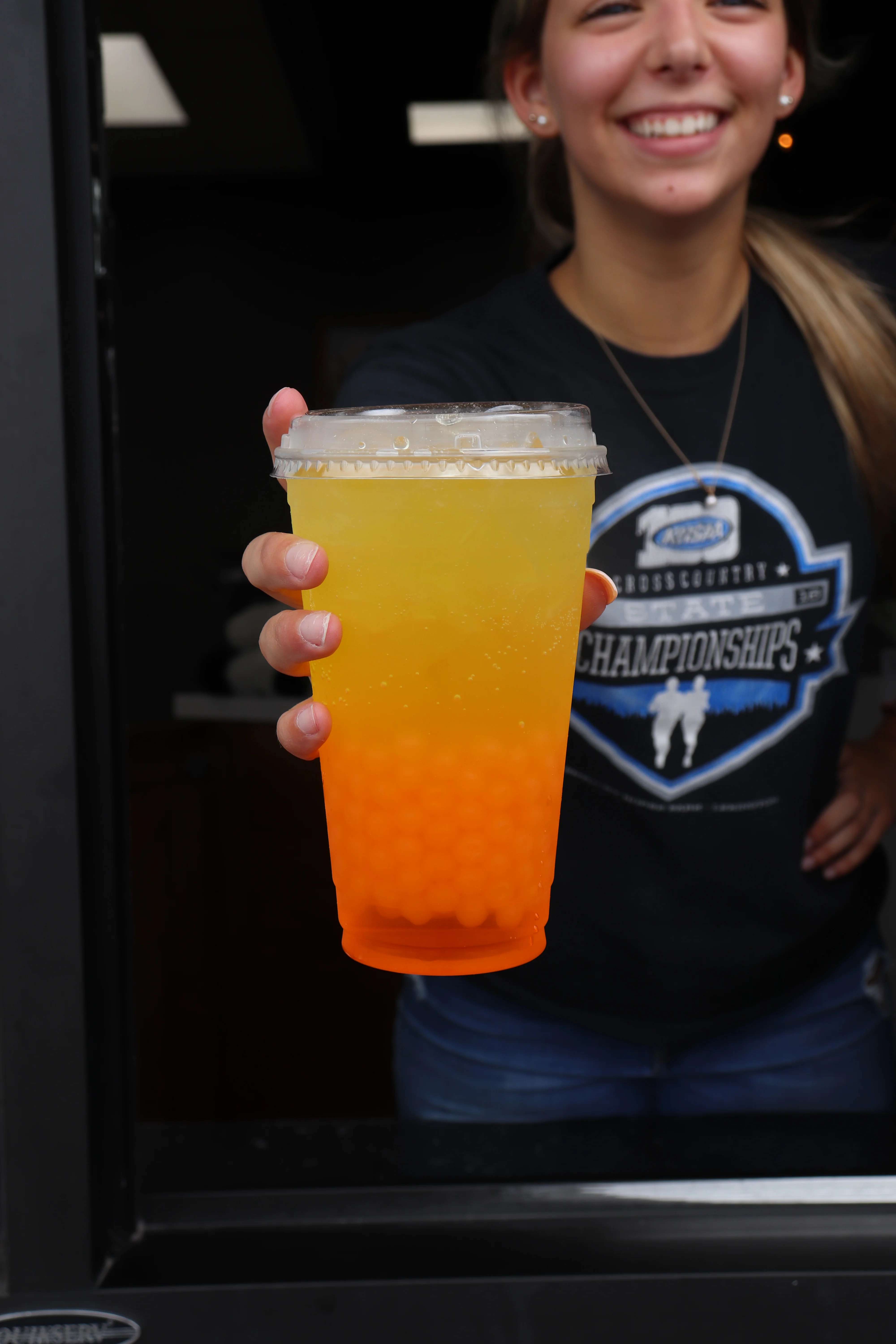 Colorful bubble tea with orange and yellow layers