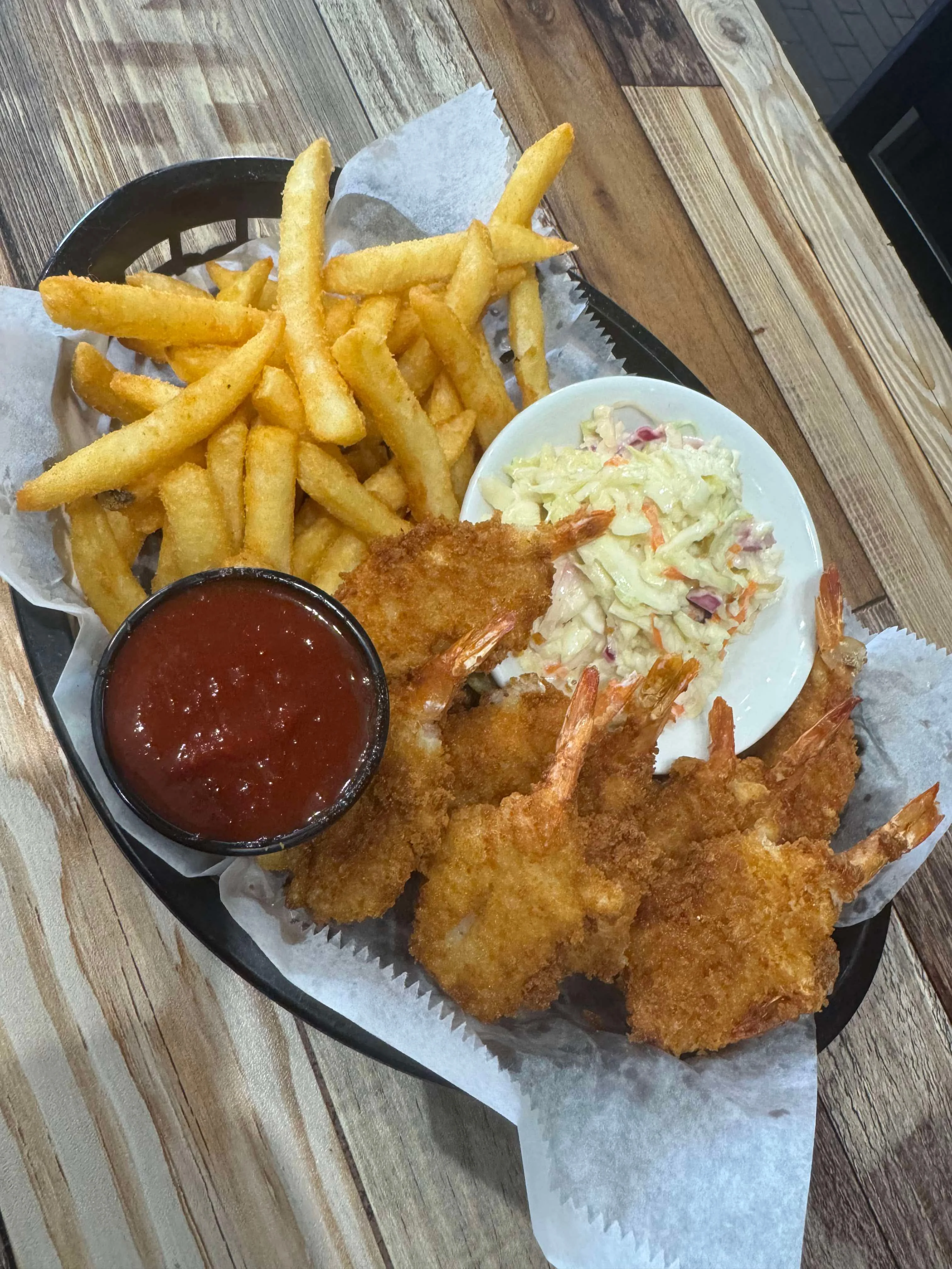 Crispy fried shrimp platter with fries and coleslaw