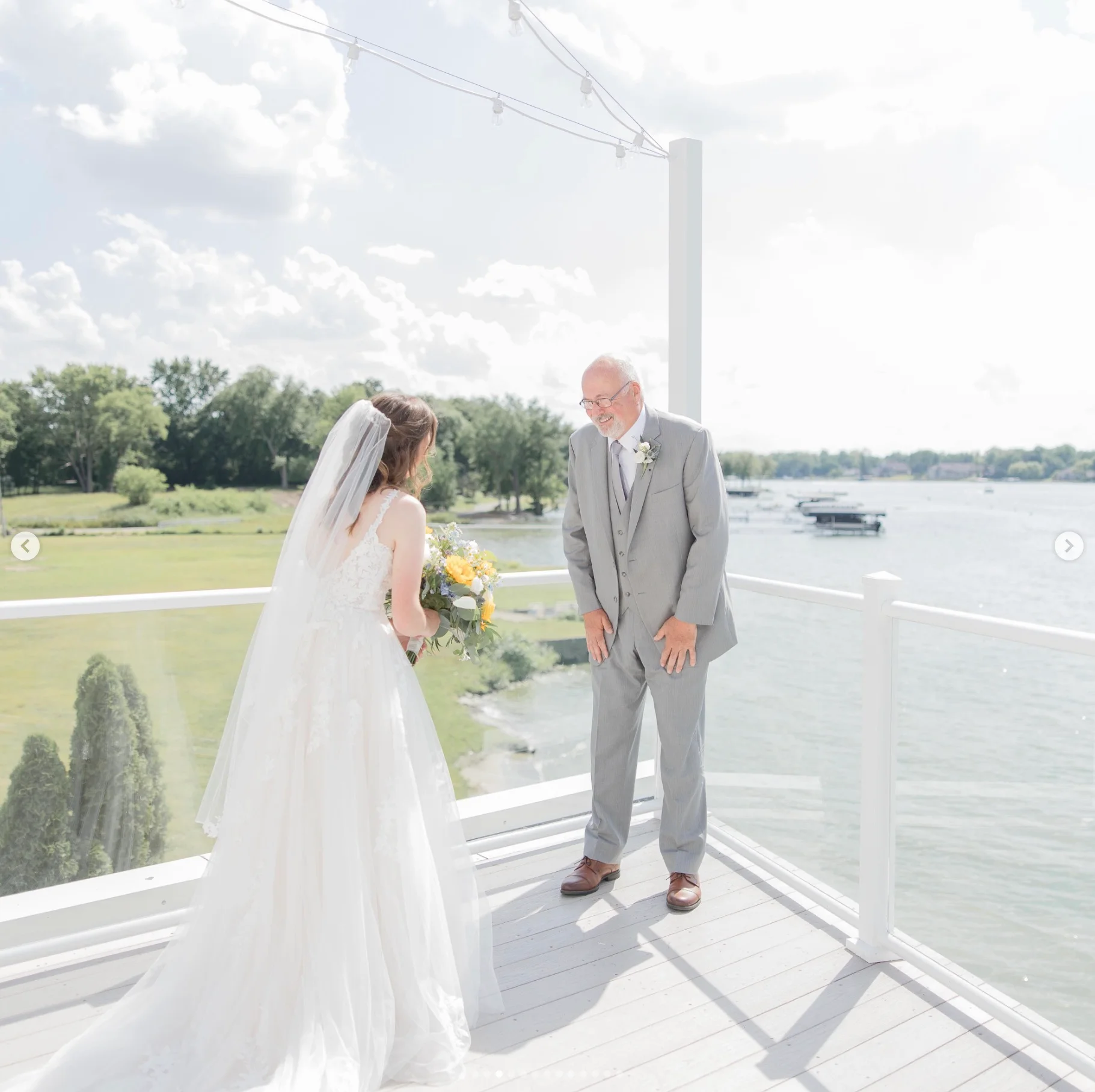Bride and father sharing a joyful moment by the water