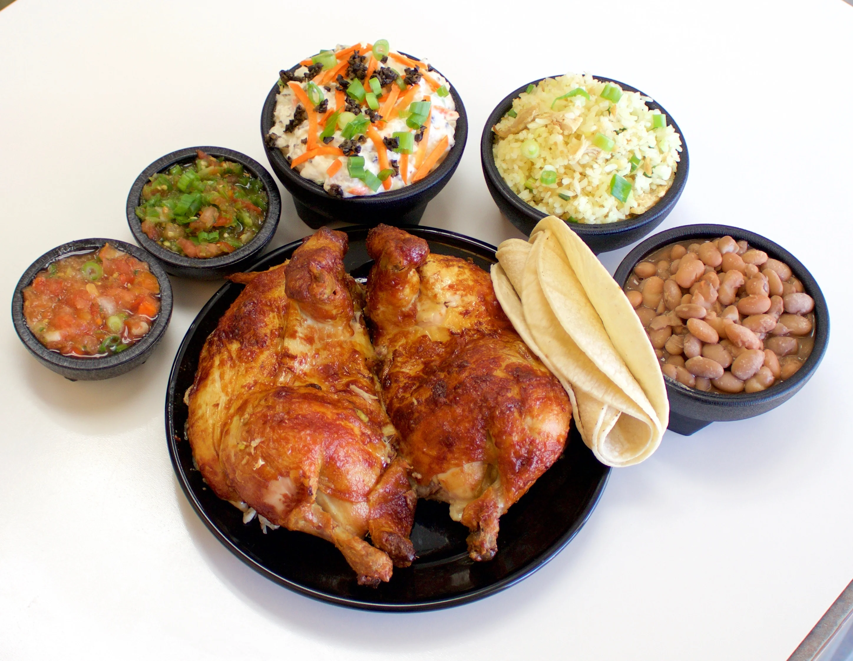 Delicious Mexican pollo asado with sides and tortillas
