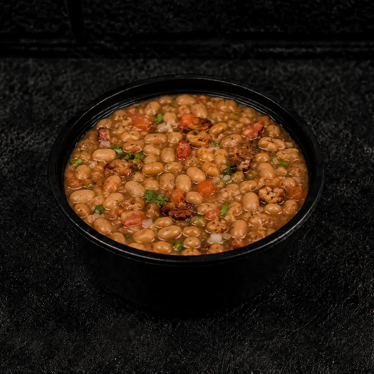 Bowl of Southern-style baked beans with savory toppings