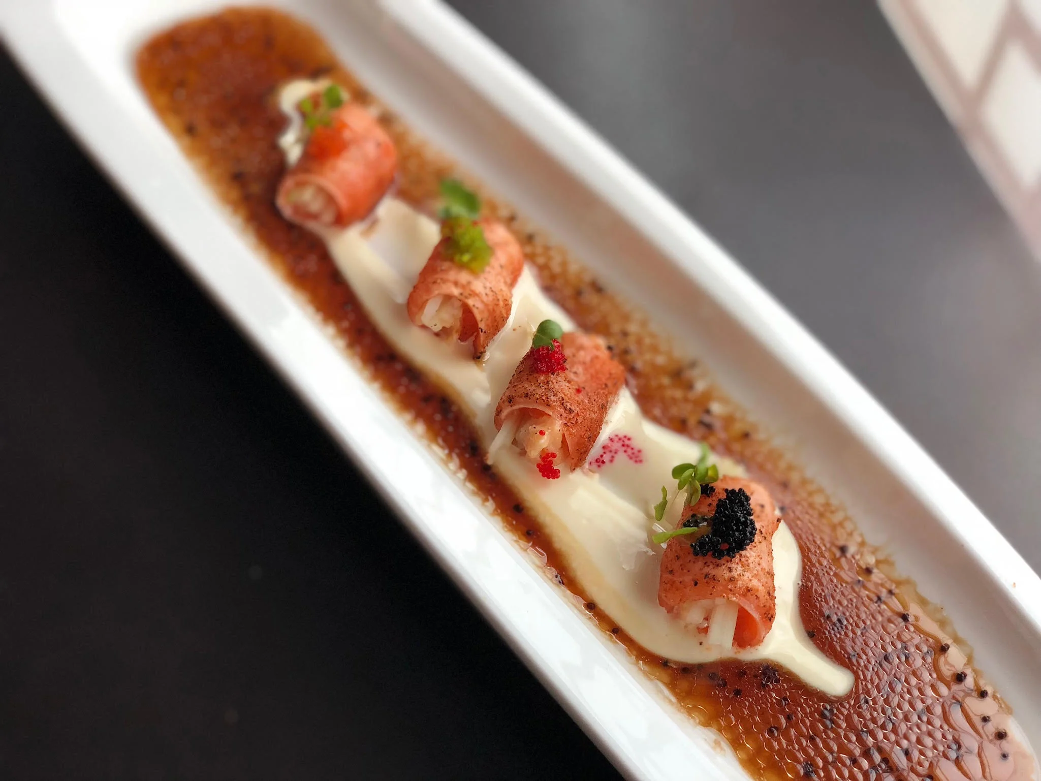 Japanese sushi rolls with creamy sauce and garnishes