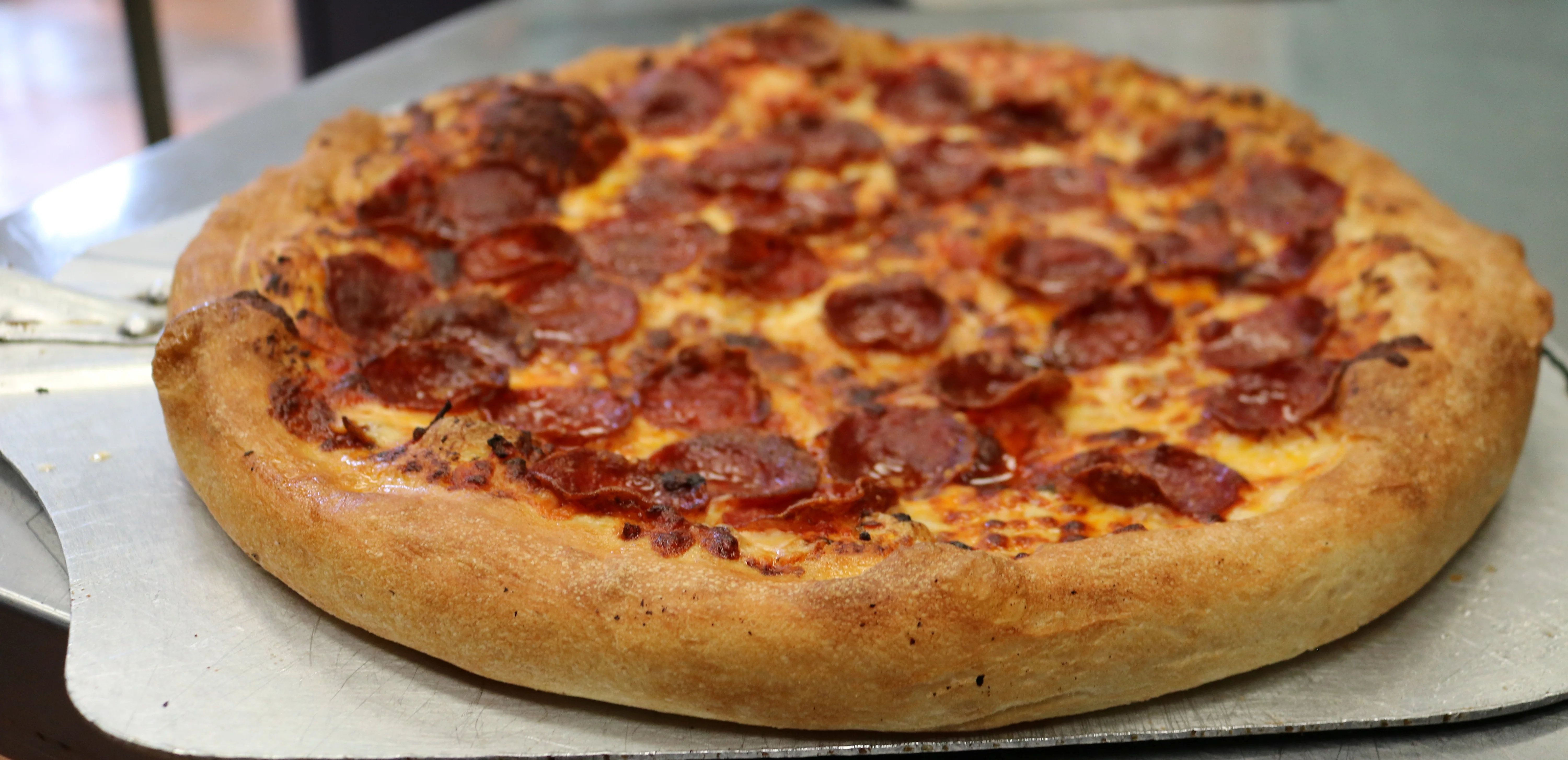 Pepperoni pizza with a golden crust from a pizzeria