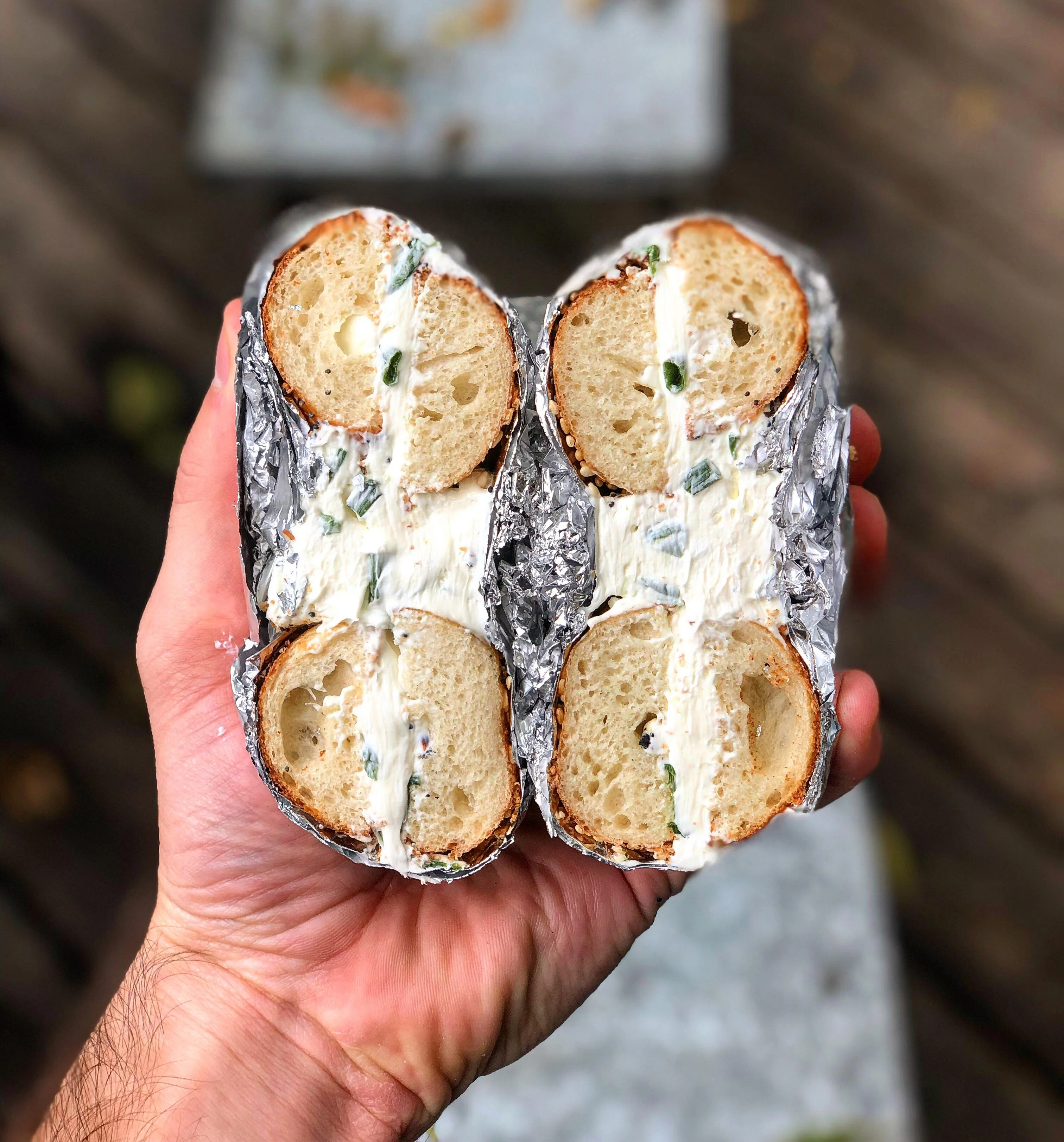 Bagel with cream cheese and herbs, served in foil