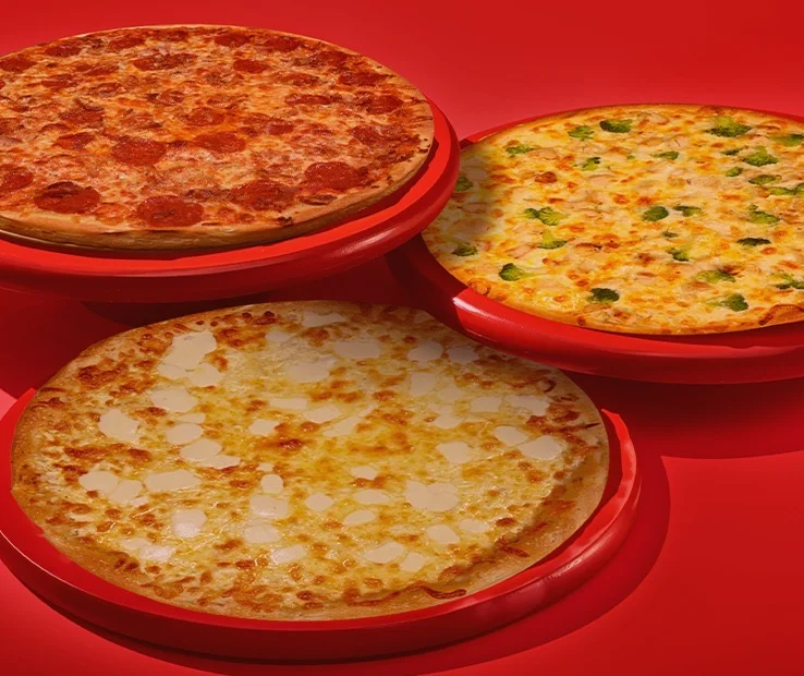 Three delicious pizzas: pepperoni, cheese, and veggie on red background