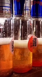 Chilled craft beers in glass bottles with frothy heads