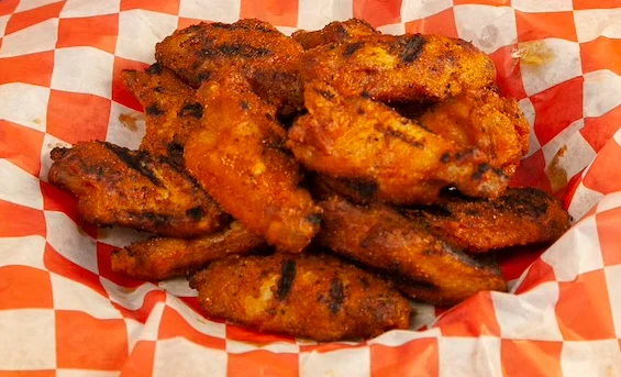 Crispy buffalo chicken wings served in a basket