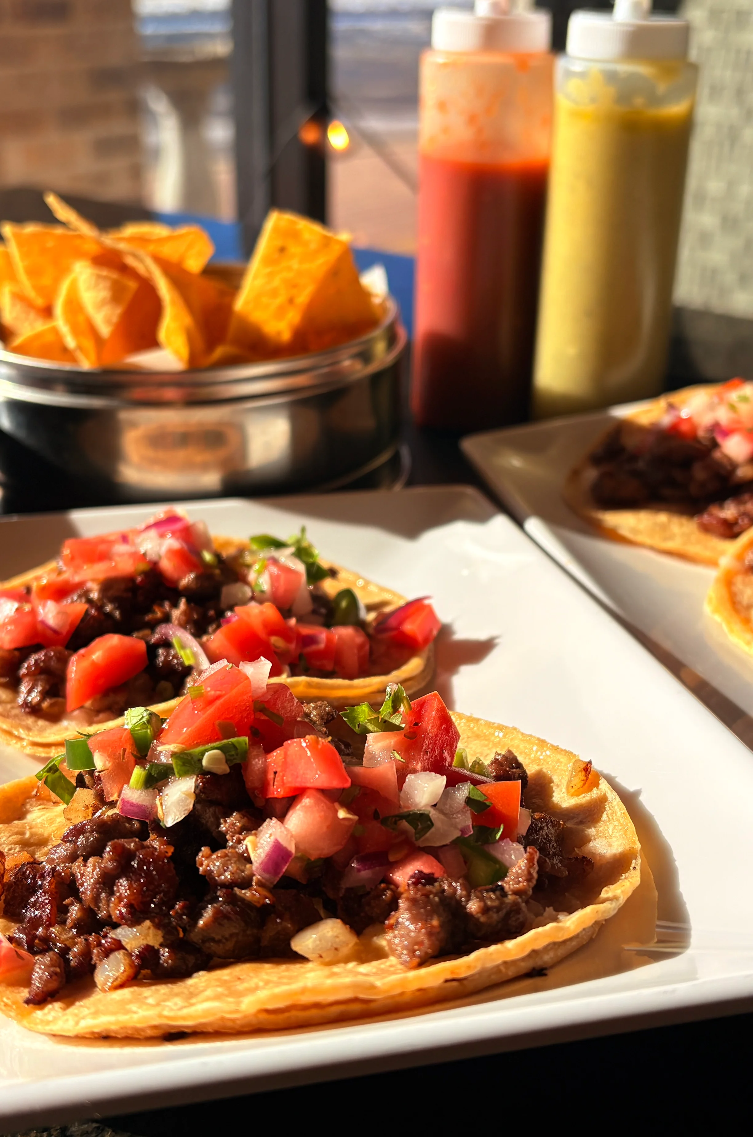 Authentic Mexican tacos al pastor with salsa and tortilla chips