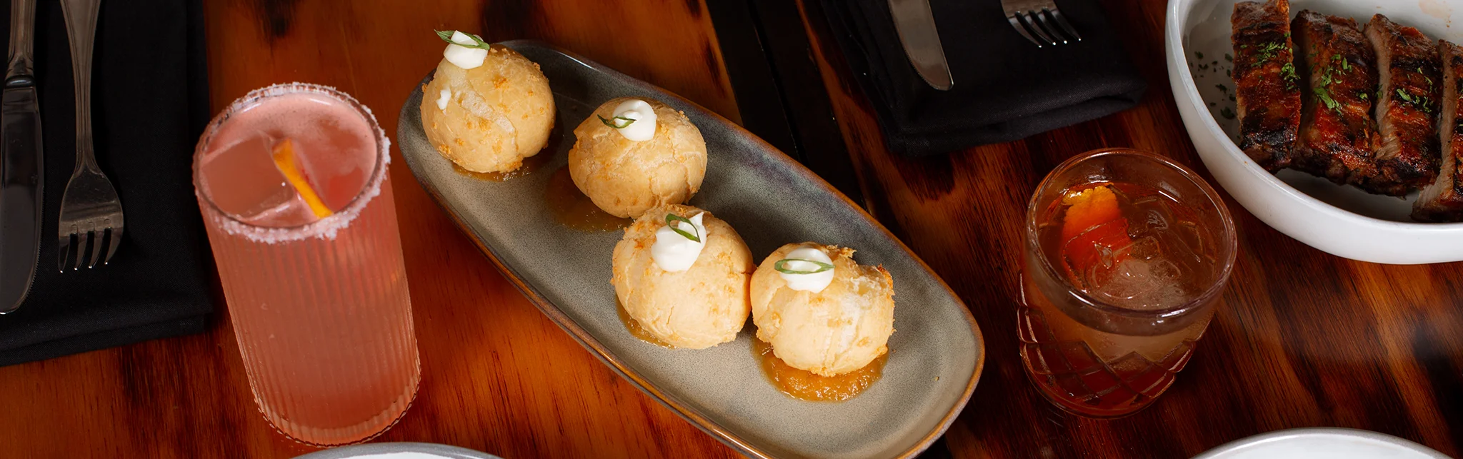 Crispy Colombian arepas with sauce in a vibrant restaurant setting