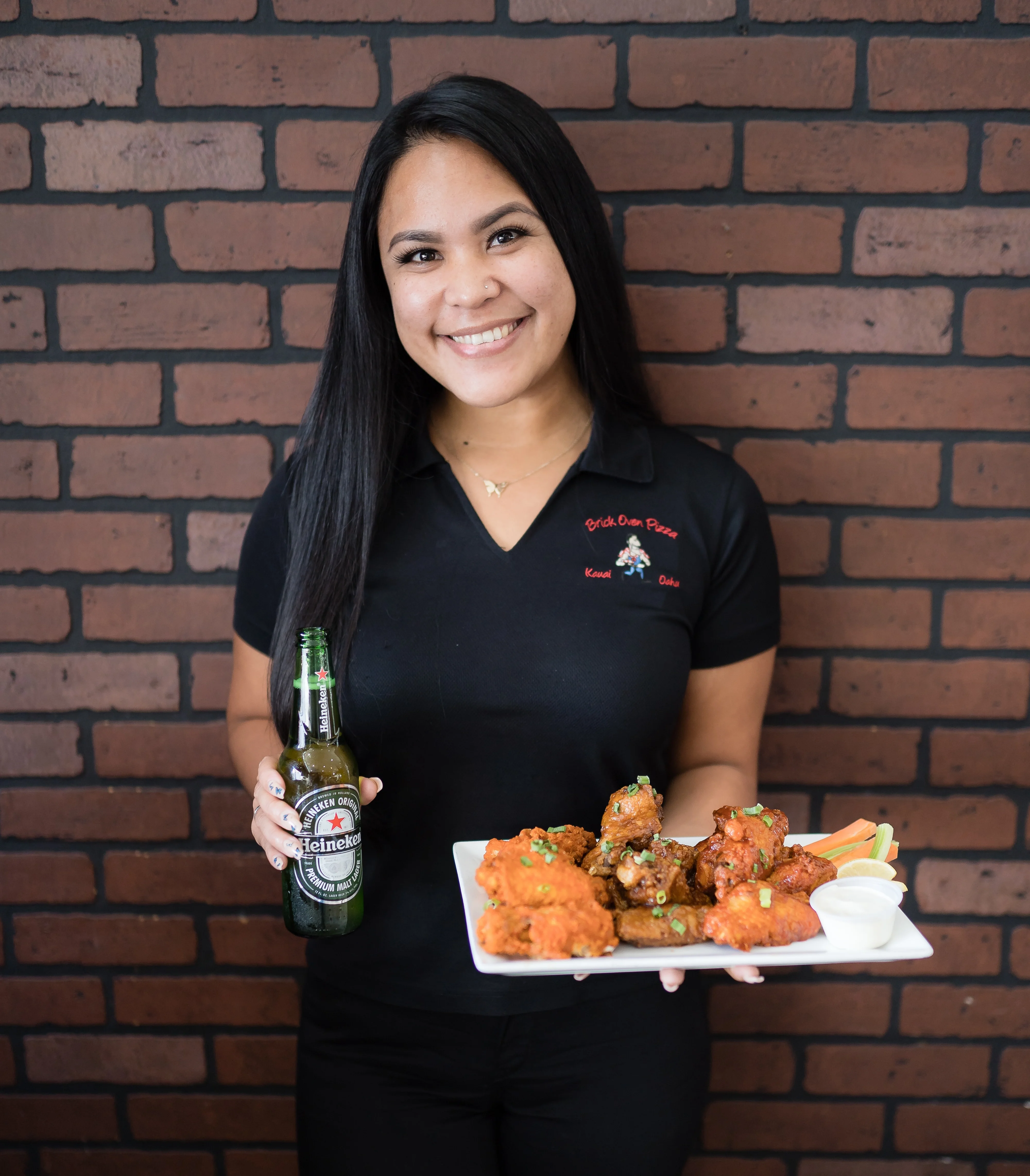 Plate of crispy chicken wings with dipping sauce in a cozy restaurant