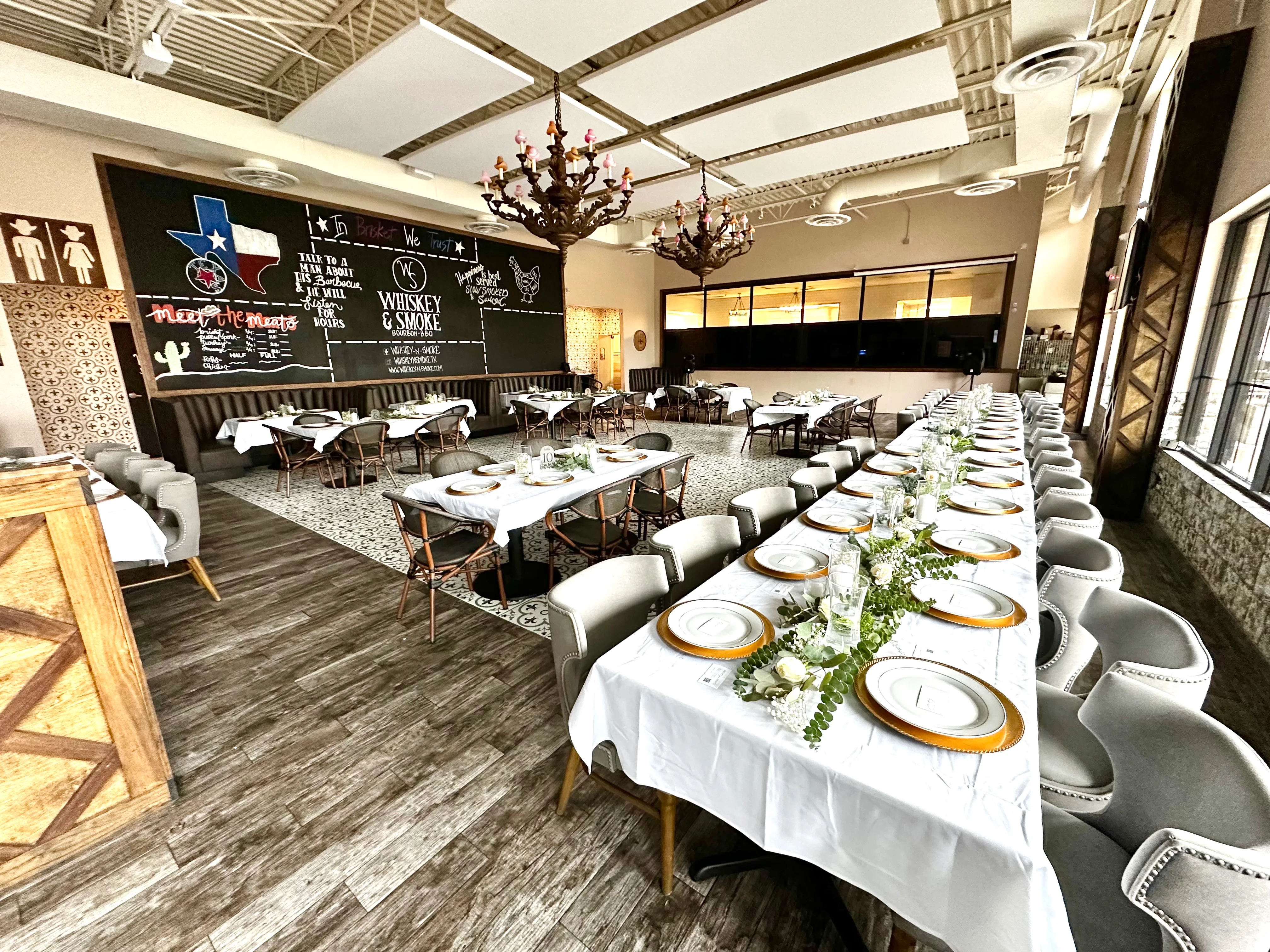 Elegant restaurant interior with long dining table and rustic decor