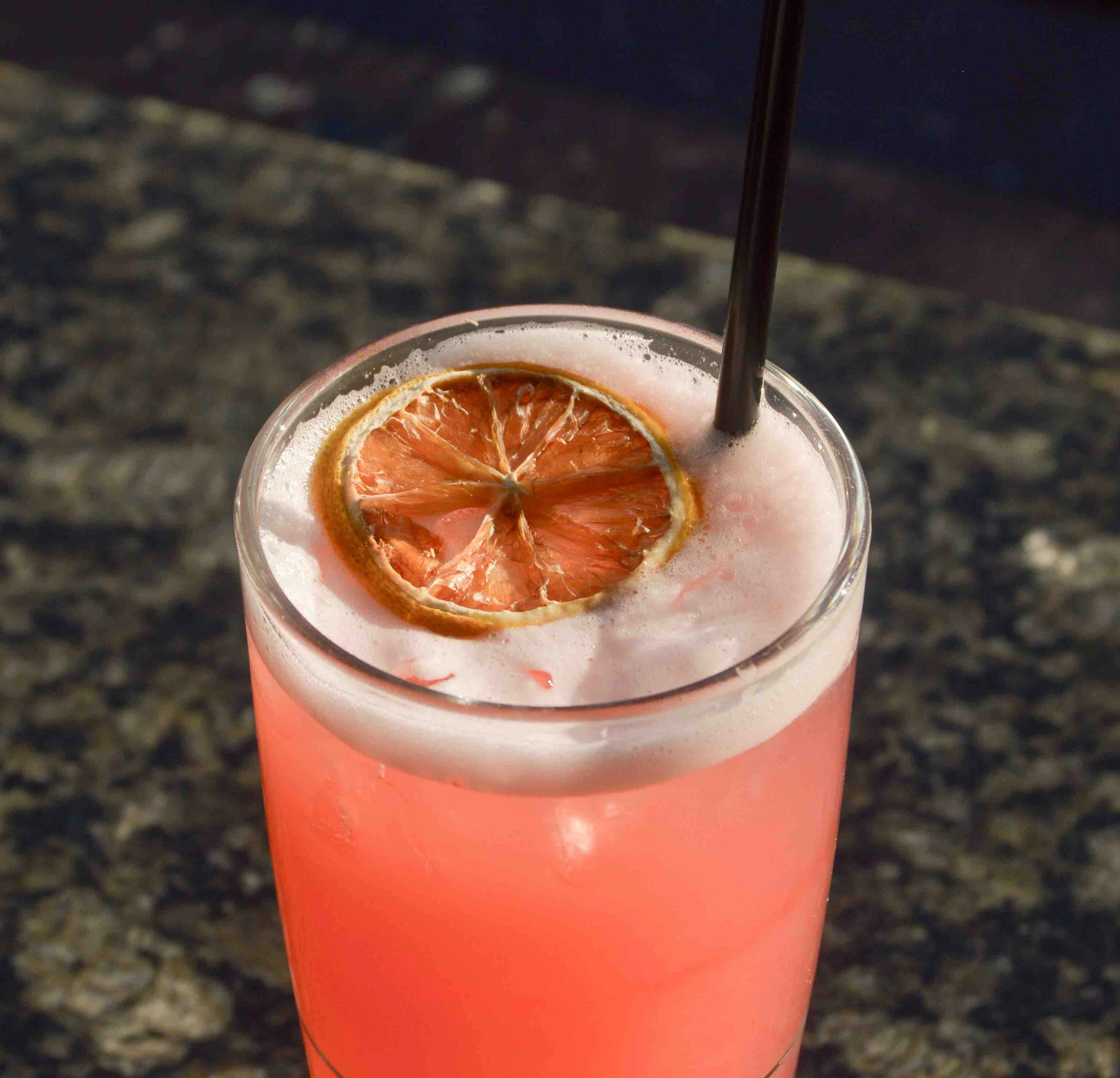 Cran You Be My Valenlime cocktail with a dried orange slice on top